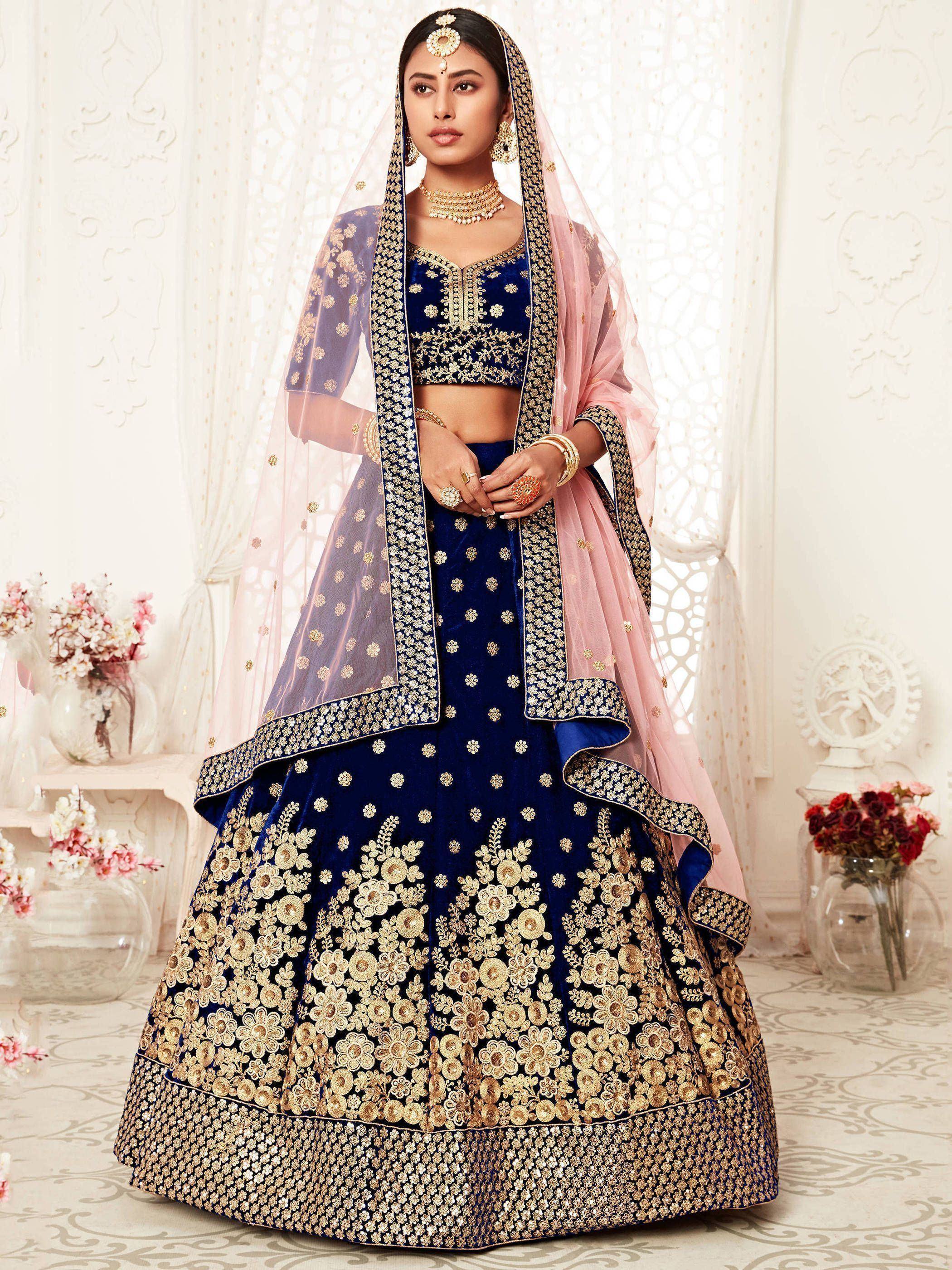 Royal blue velvet lehenga choli with gold floral embroidery, sheer dupatta, perfect for Indian weddings and festive occasions.