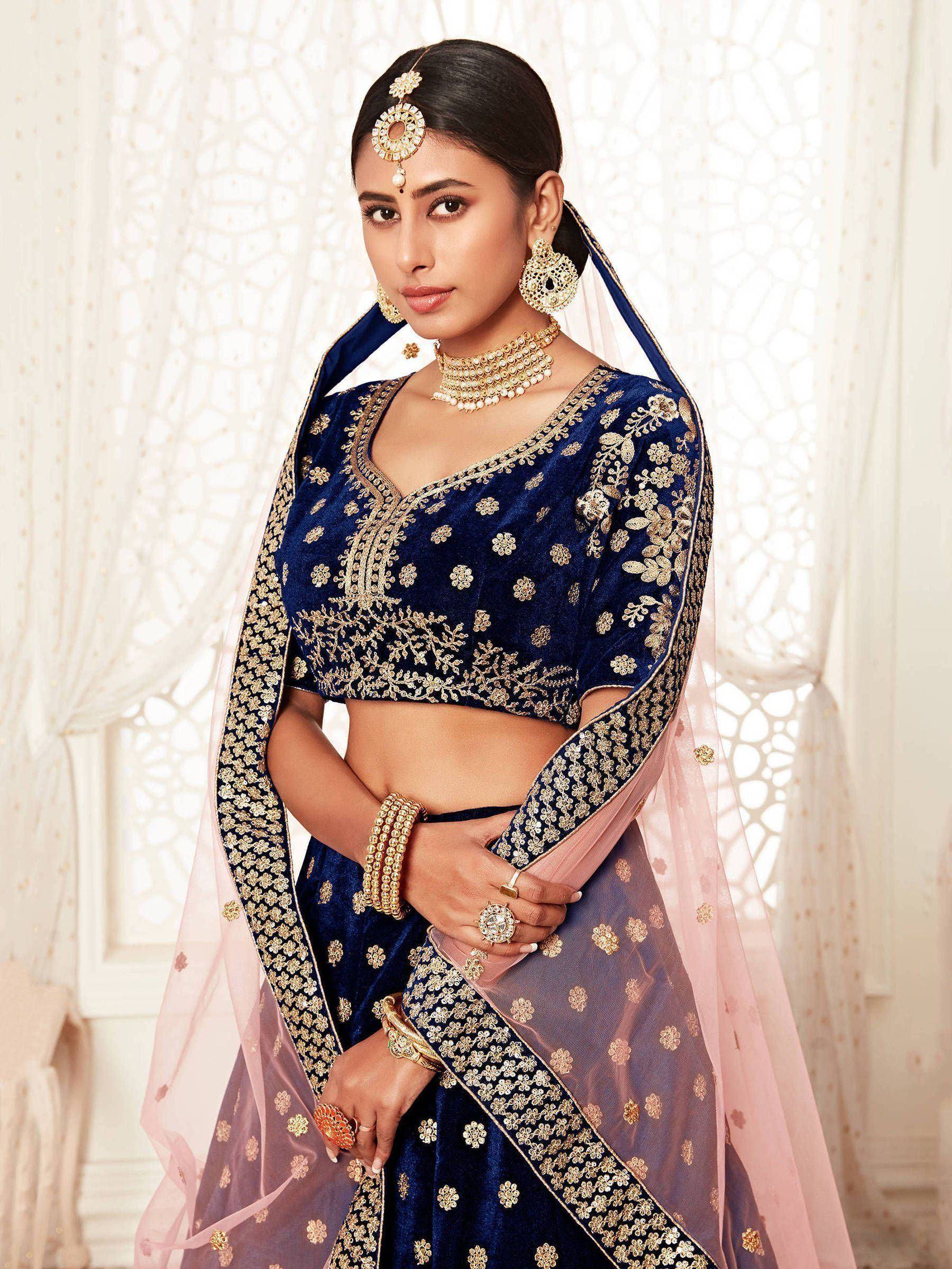 Blue velvet lehenga choli with gold embroidery, perfect for Indian weddings and festive occasions