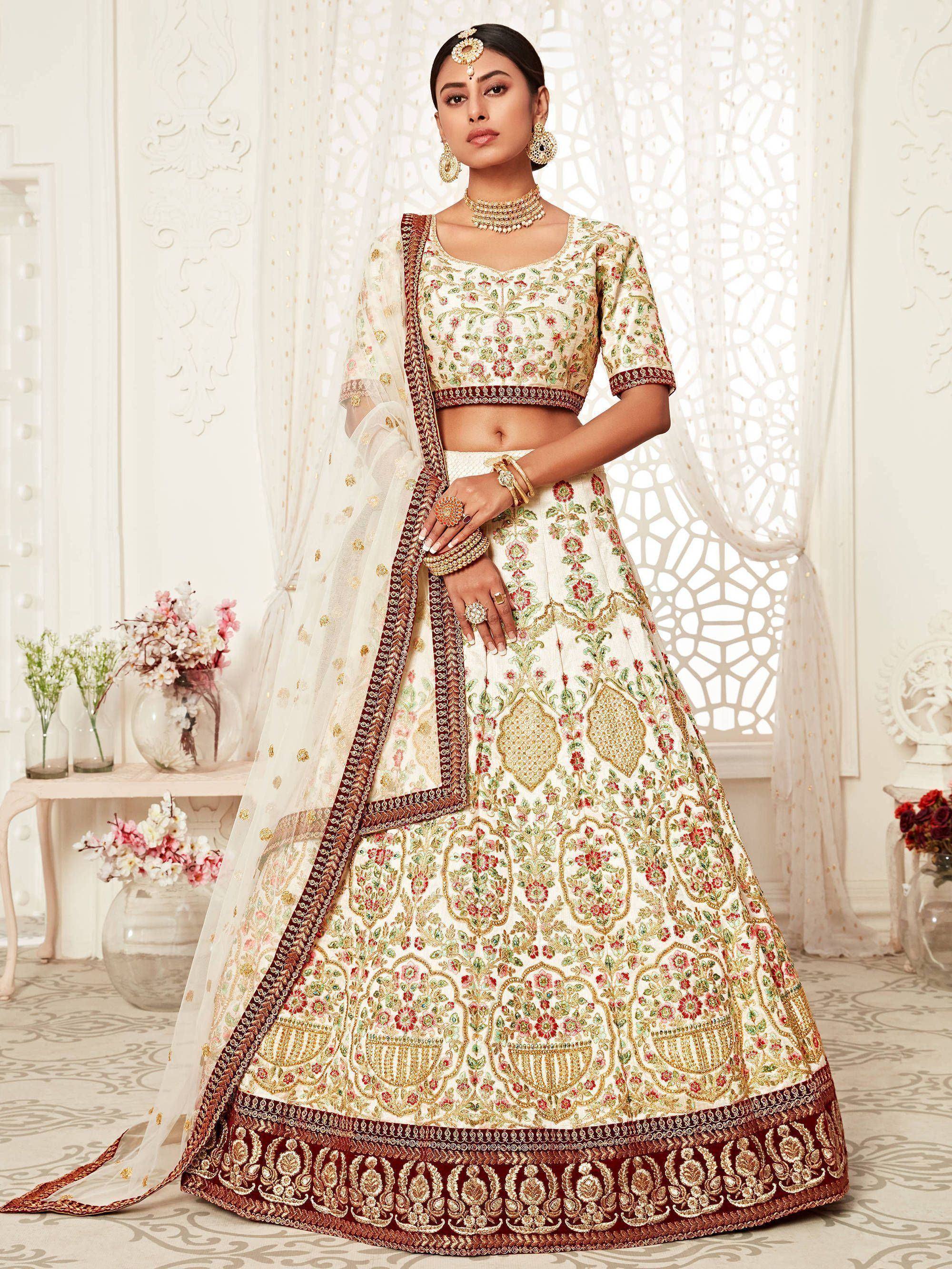 Elegant ivory lehenga choli with floral embroidery, perfect for Indian weddings and festive occasions.