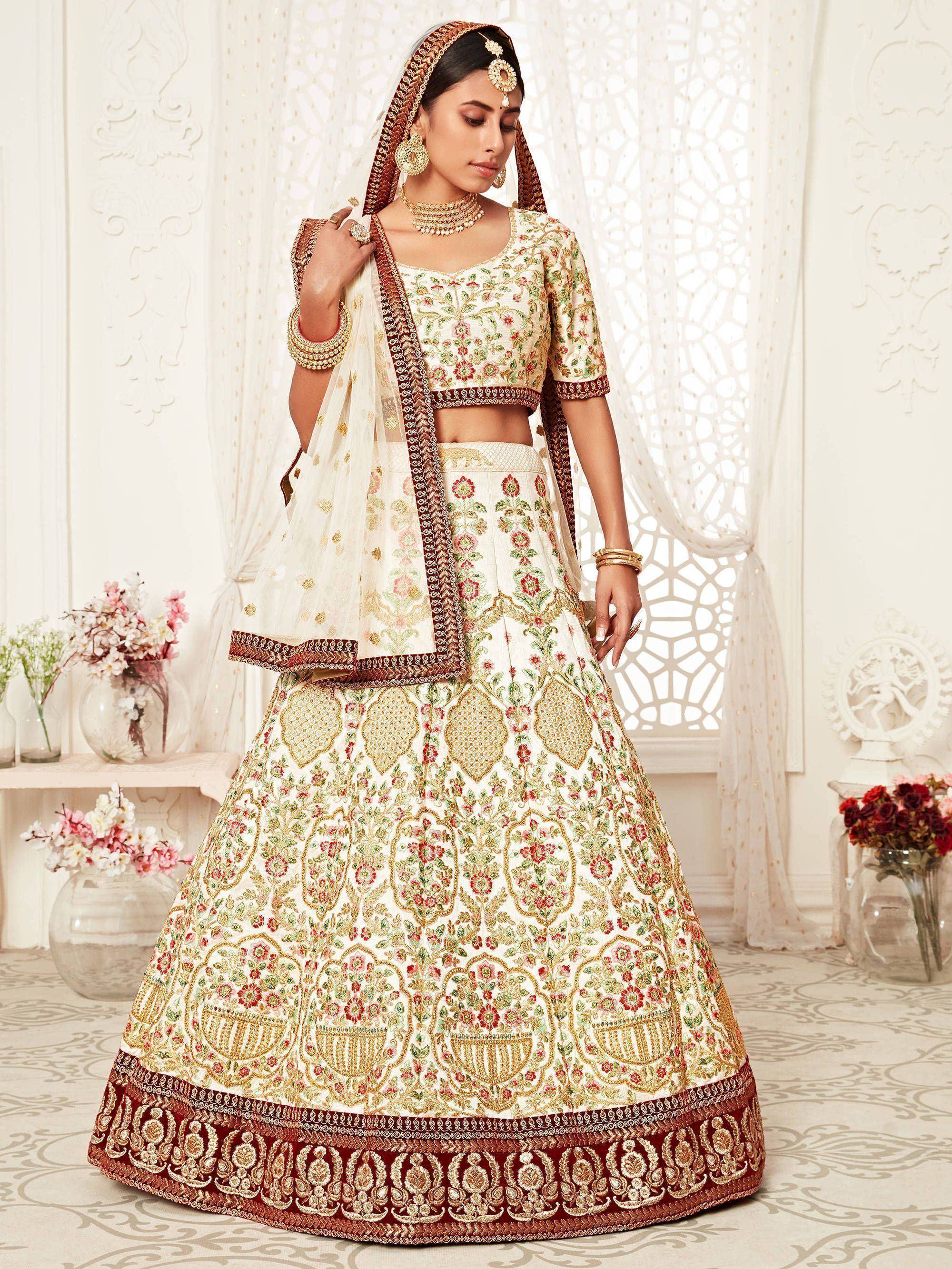 Elegant ivory lehenga choli with floral embroidery and gold detailing, perfect for Indian weddings and festive occasions.
