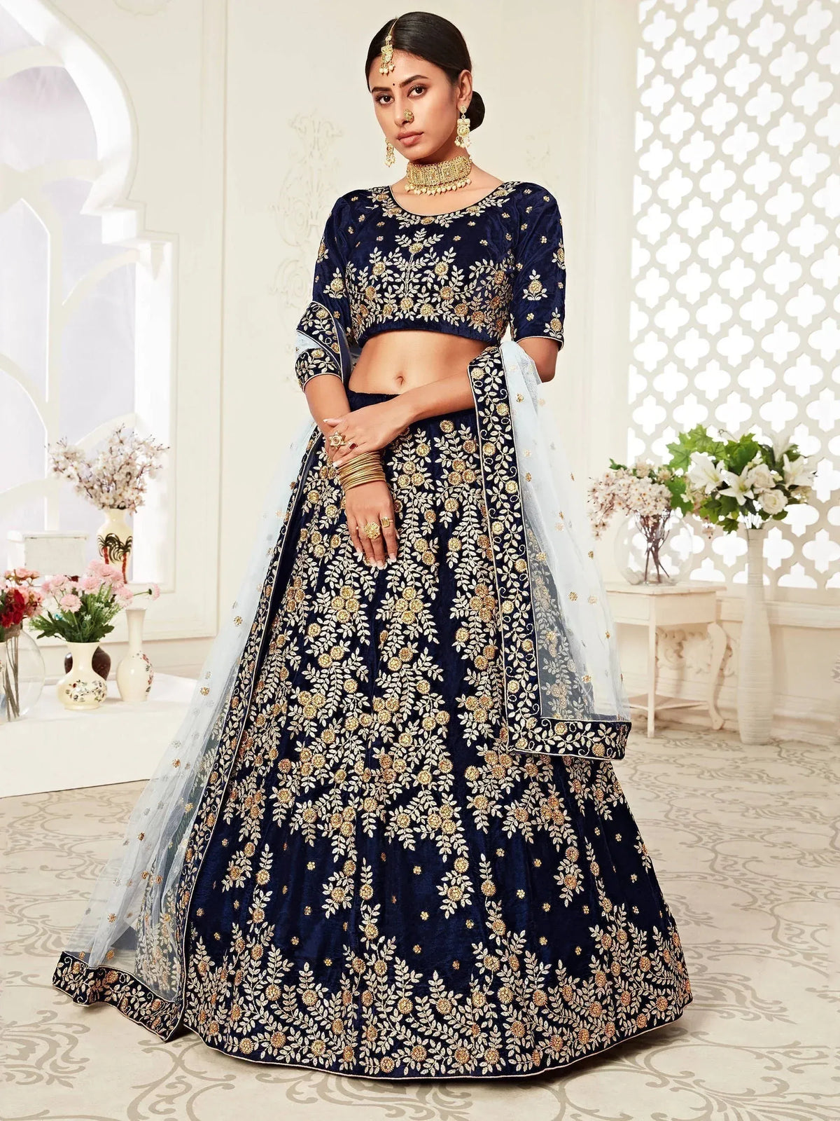 Elegant navy blue lehenga choli with gold floral embroidery and sheer dupatta for Indian ethnic wear
