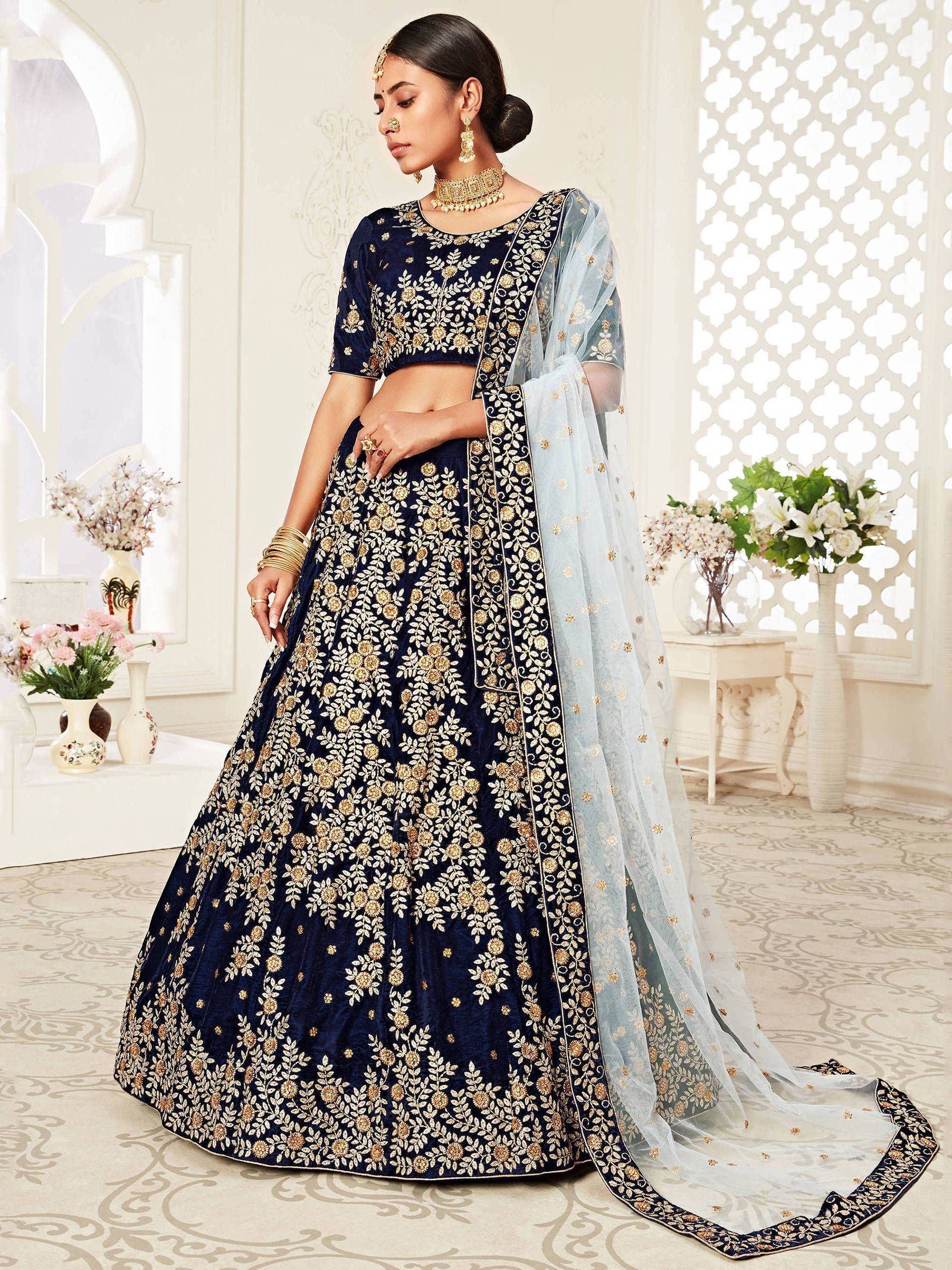 Navy blue embroidered lehenga choli with floral gold detailing and light blue dupatta, perfect for Indian weddings.