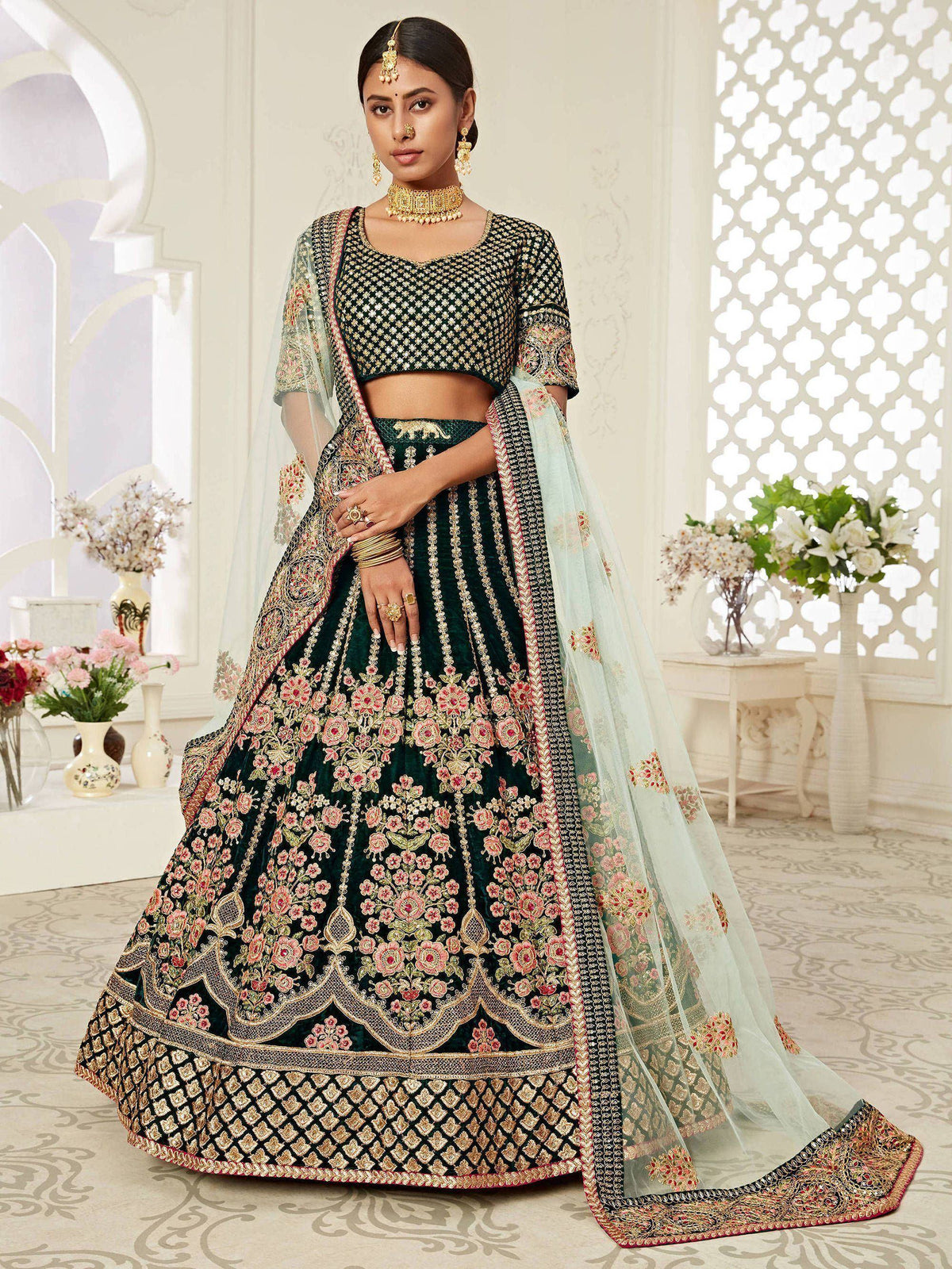 Elegant green embroidered lehenga choli with floral motifs and sheer dupatta, perfect for Indian weddings and festive occasions.