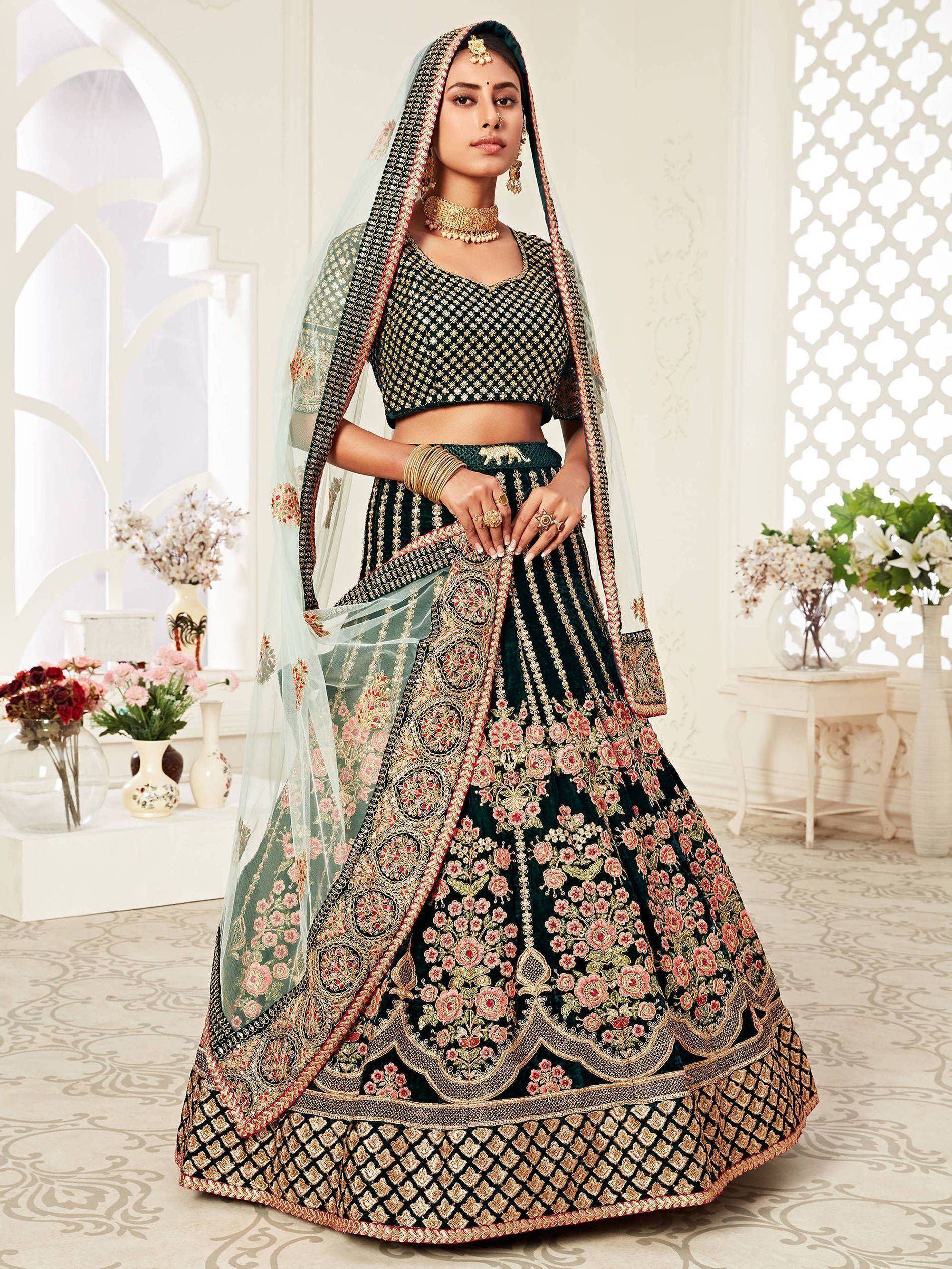 Elegant dark green lehenga choli with gold floral embroidery and sheer dupatta, perfect for Indian weddings