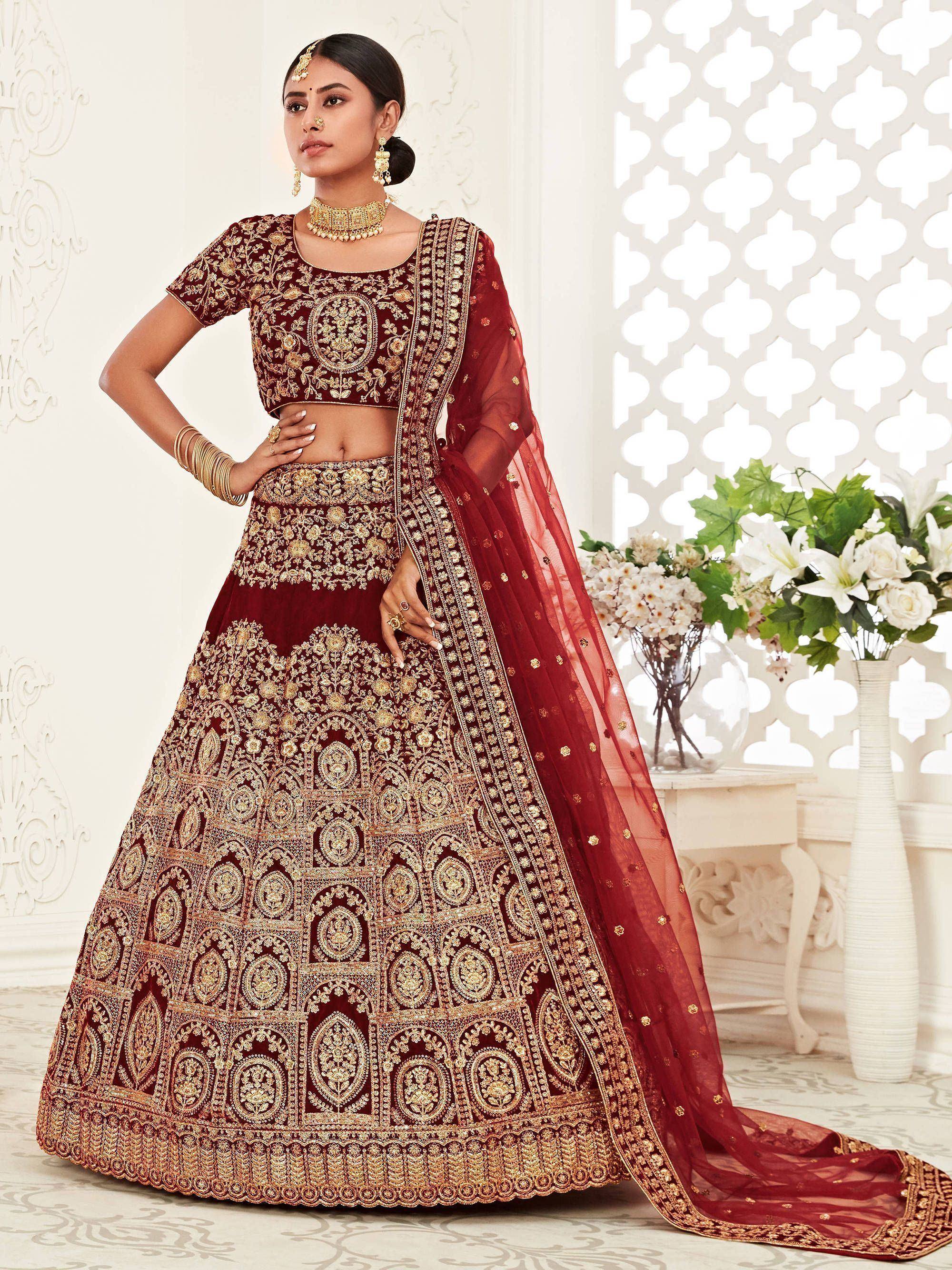 Maroon designer lehenga choli with heavy gold embroidery, perfect for weddings and ethnic events