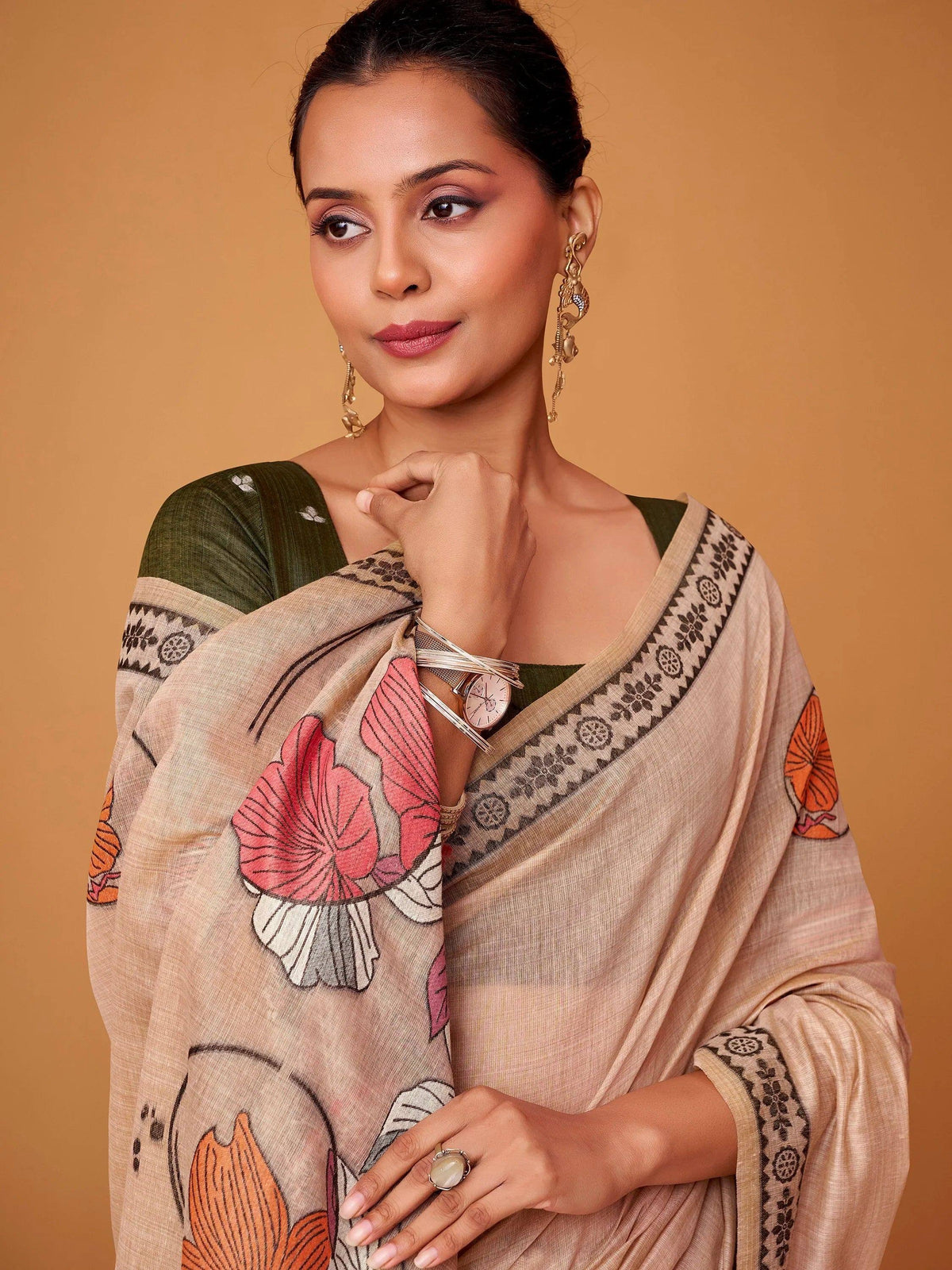 Woman in beige floral saree with green blouse, ethnic jewelry, perfect for Indian occasions