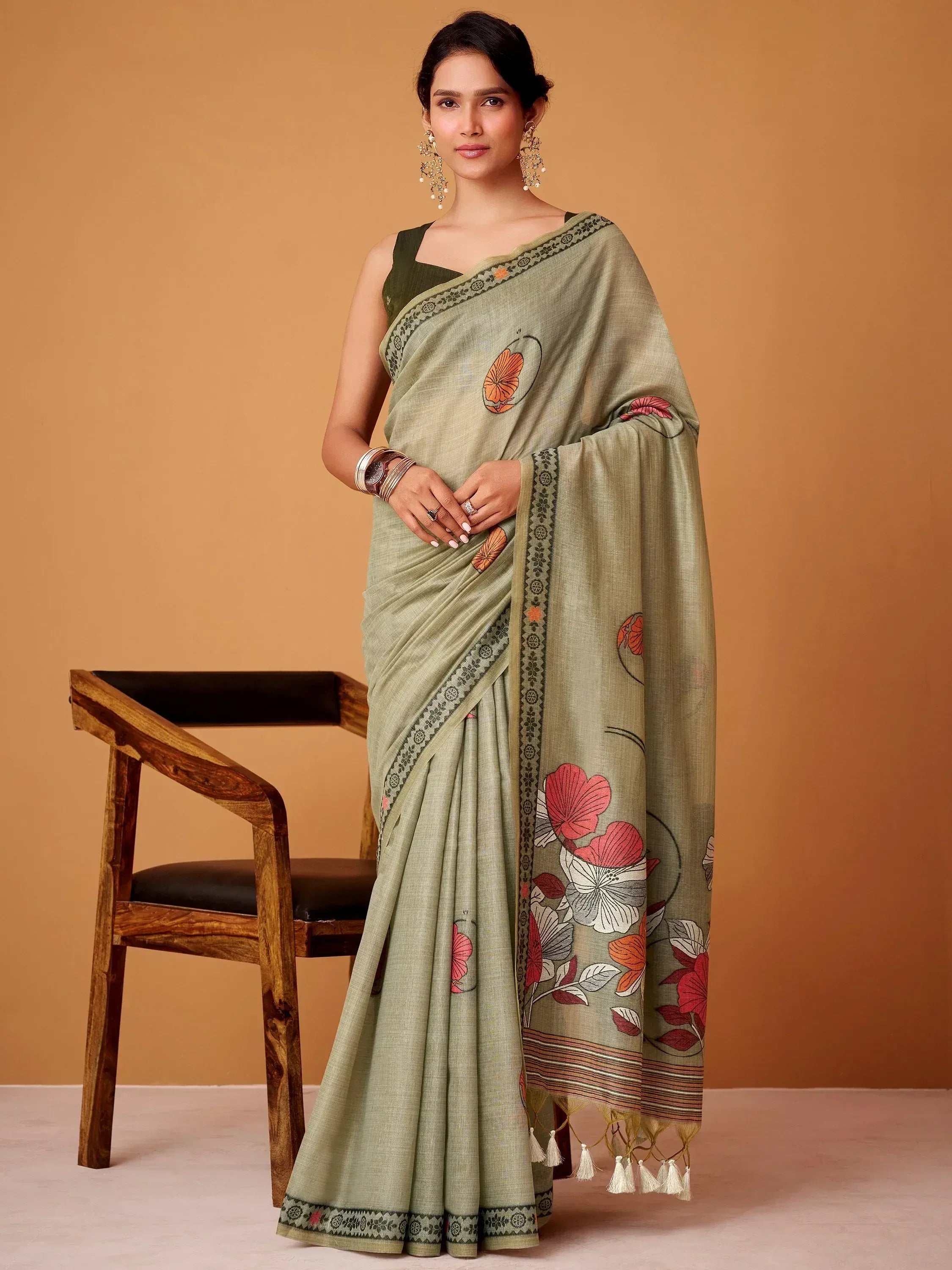 Olive green floral print saree with embroidered border and tassels, paired with matching blouse