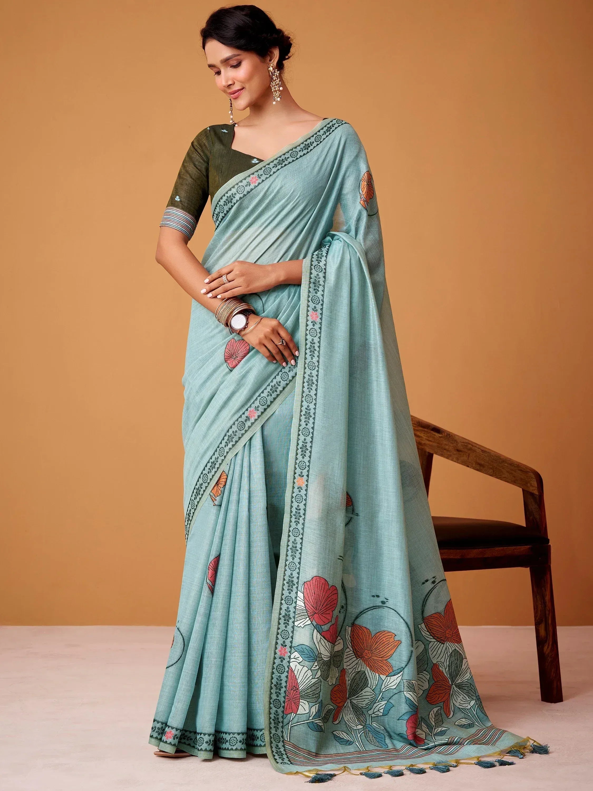 Light blue floral print saree with embroidered border and matching blouse, ideal for ethnic occasions