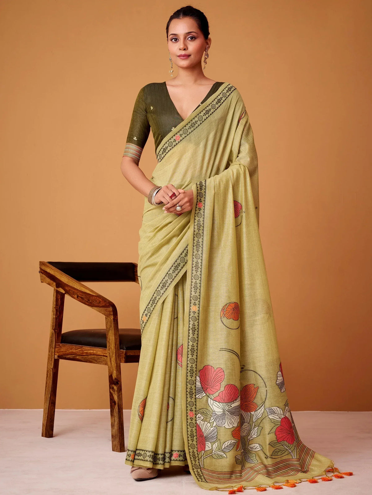 Light green floral printed saree with embroidered border, paired with matching blouse, ideal for ethnic occasions.