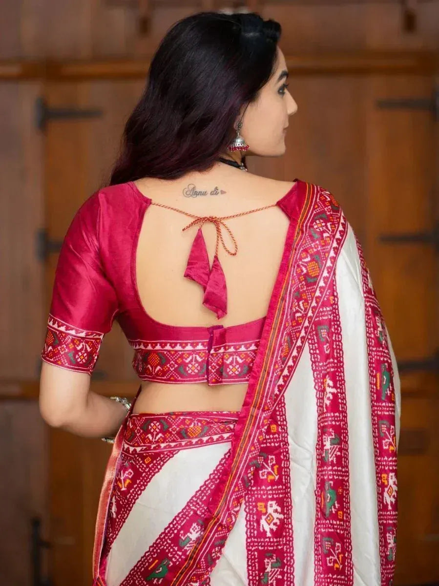 Woman in red and white ethnic saree with backless blouse, traditional Indian wear