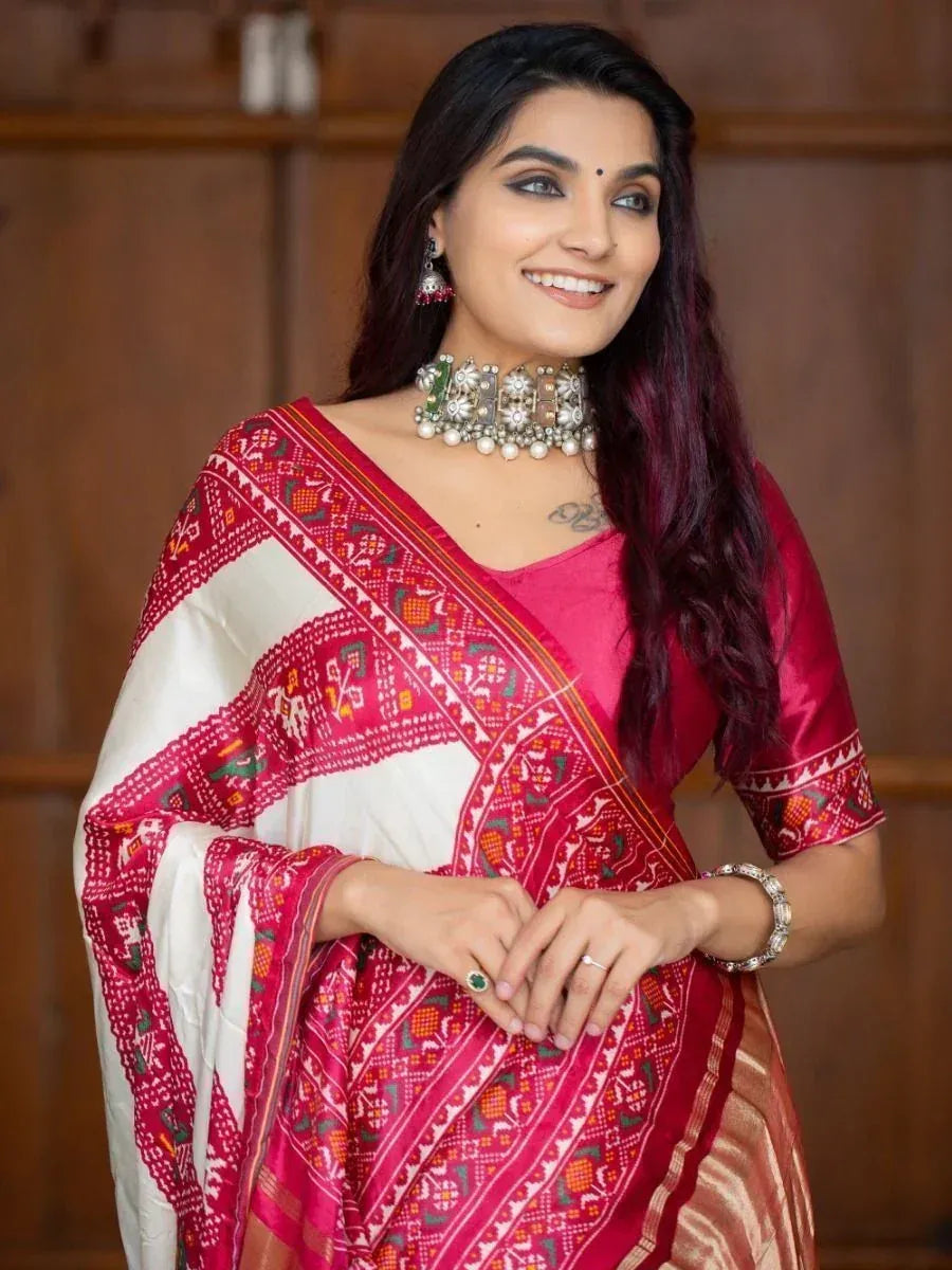 Woman in red and white embroidered saree with traditional jewelry, perfect for ethnic occasions