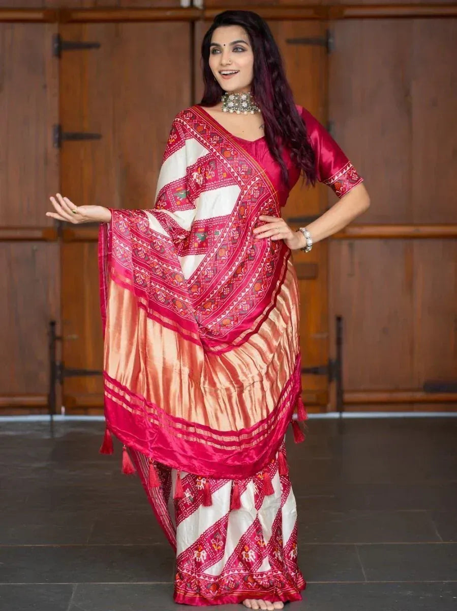 Woman in vibrant pink and white embroidered saree with tassels, styled for Indian ethnic wear