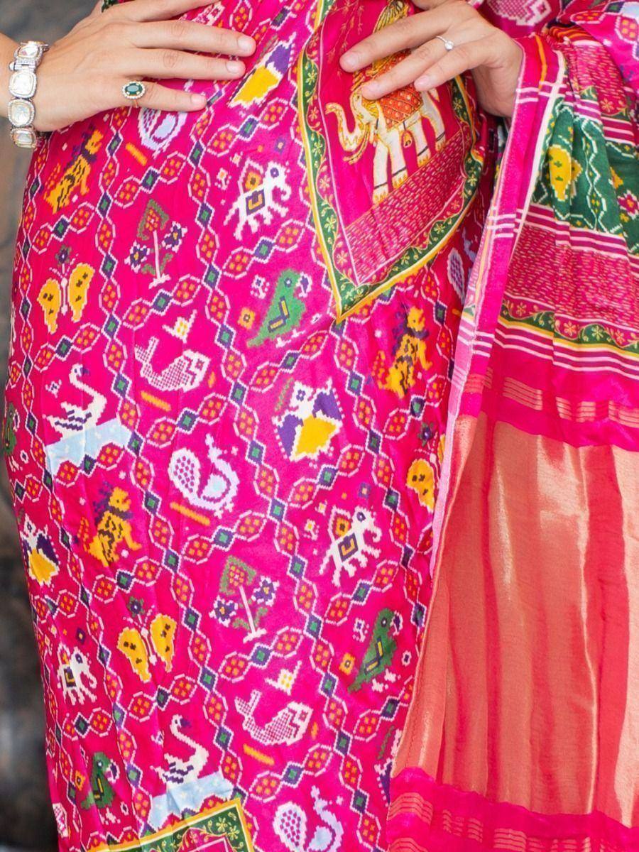 Vibrant pink ethnic saree with elephant and bird motifs, perfect for Indian festive wear
