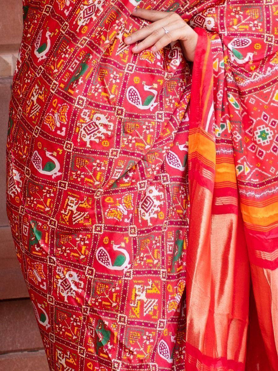 Vibrant red ethnic saree with peacock and geometric block print, perfect for Indian celebrations