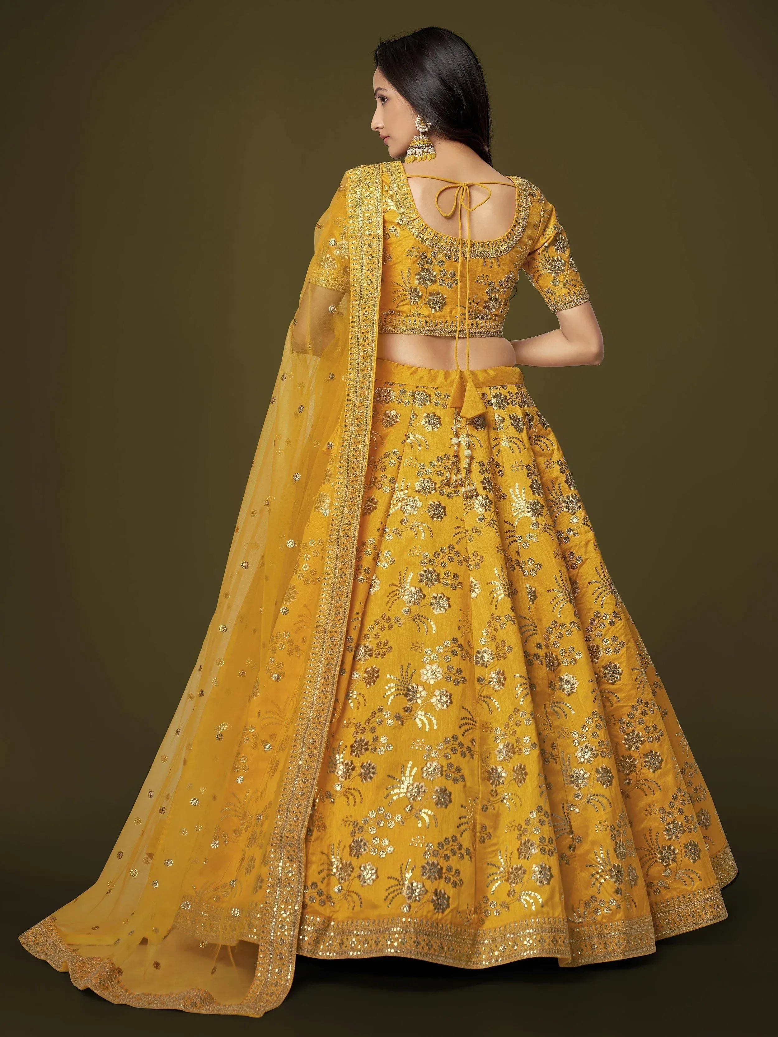 Yellow embroidered lehenga choli with floral motifs and sheer dupatta, perfect for Indian ethnic occasions