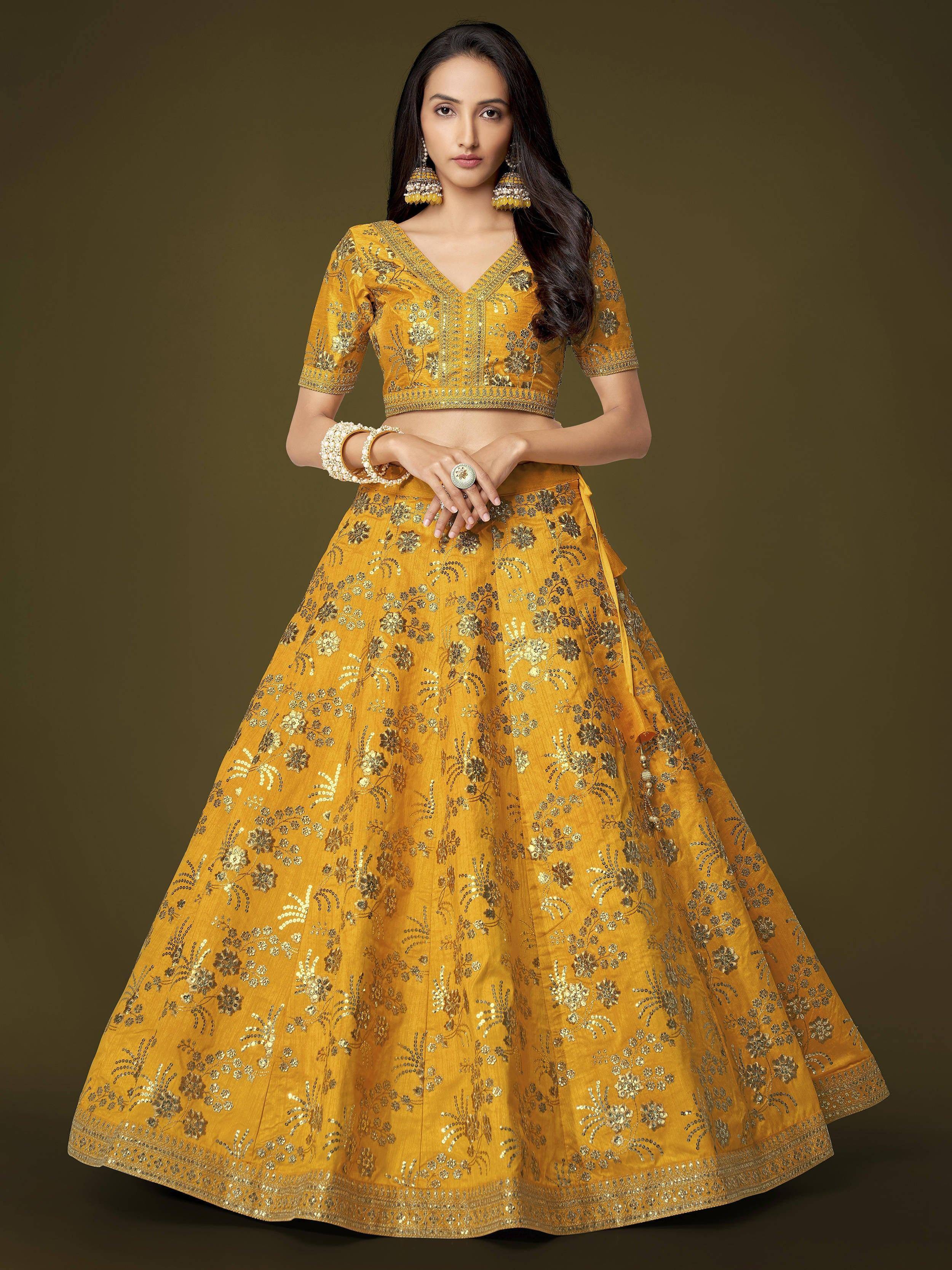 Yellow embroidered lehenga choli with floral gold detailing, perfect for Indian ethnic wear occasions