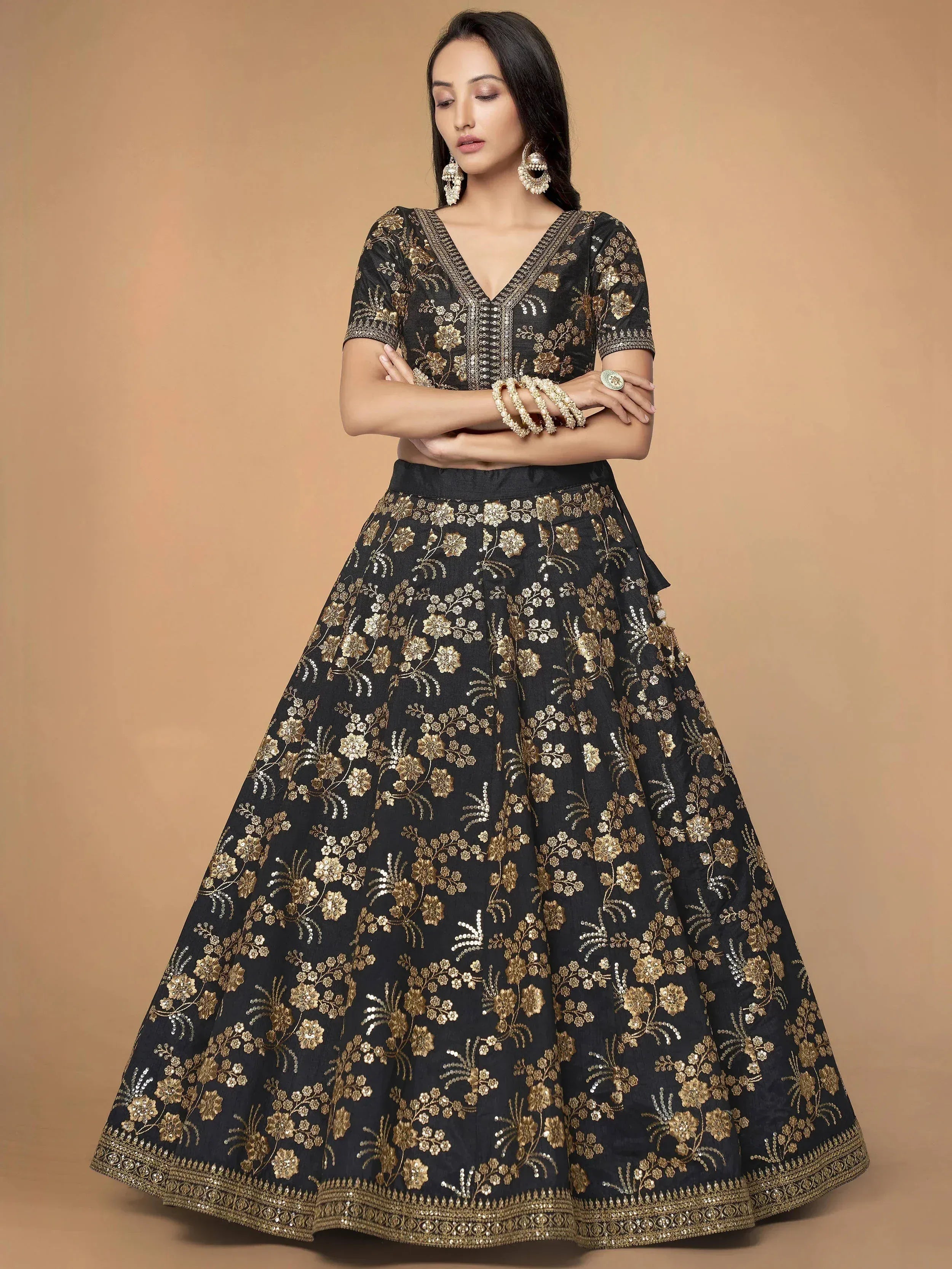 Black and gold embroidered lehenga choli with floral zari work, perfect for Indian ethnic occasions.