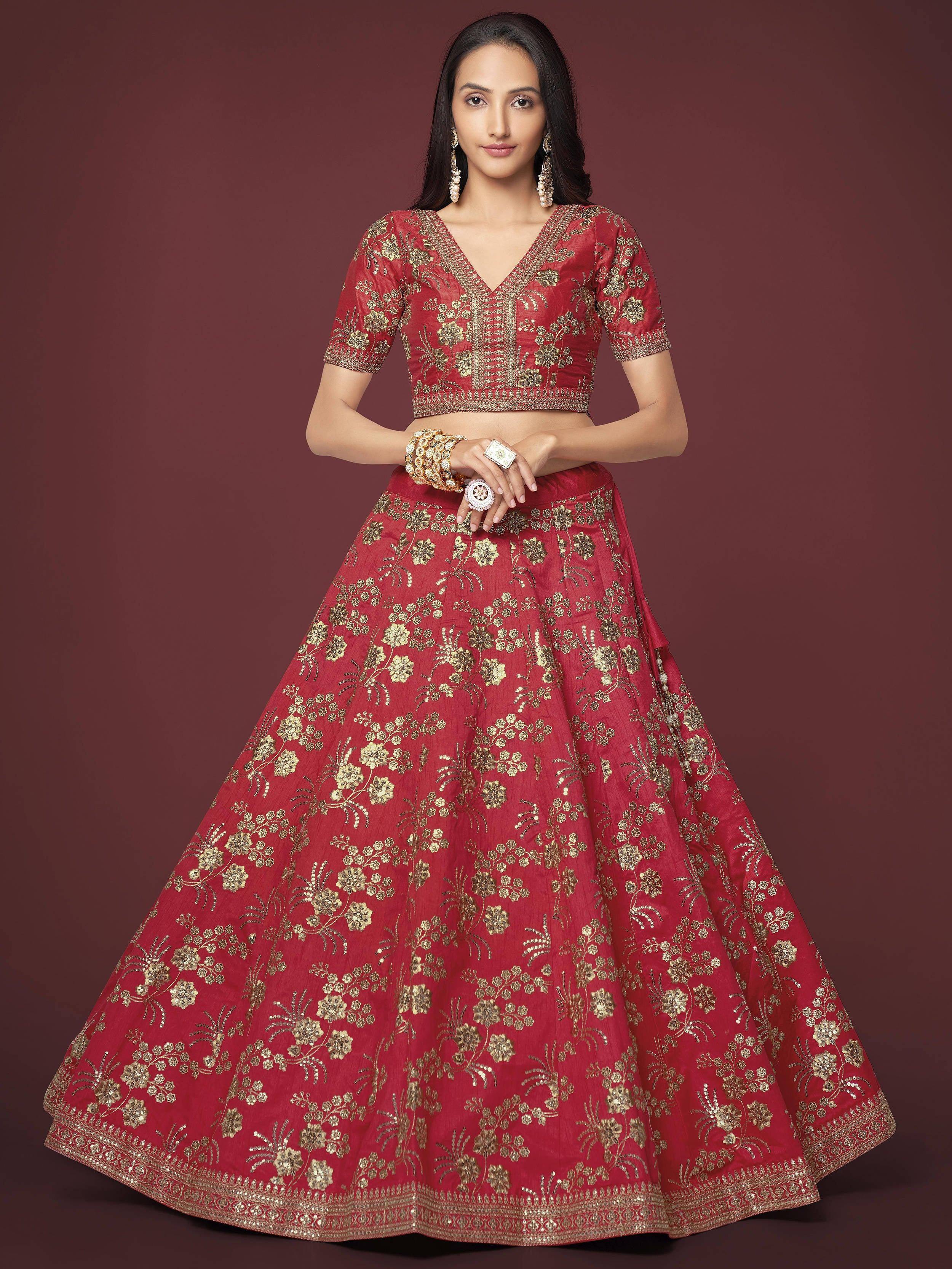 Red and gold embroidered lehenga choli with floral zari work, perfect for Indian weddings and festive occasions