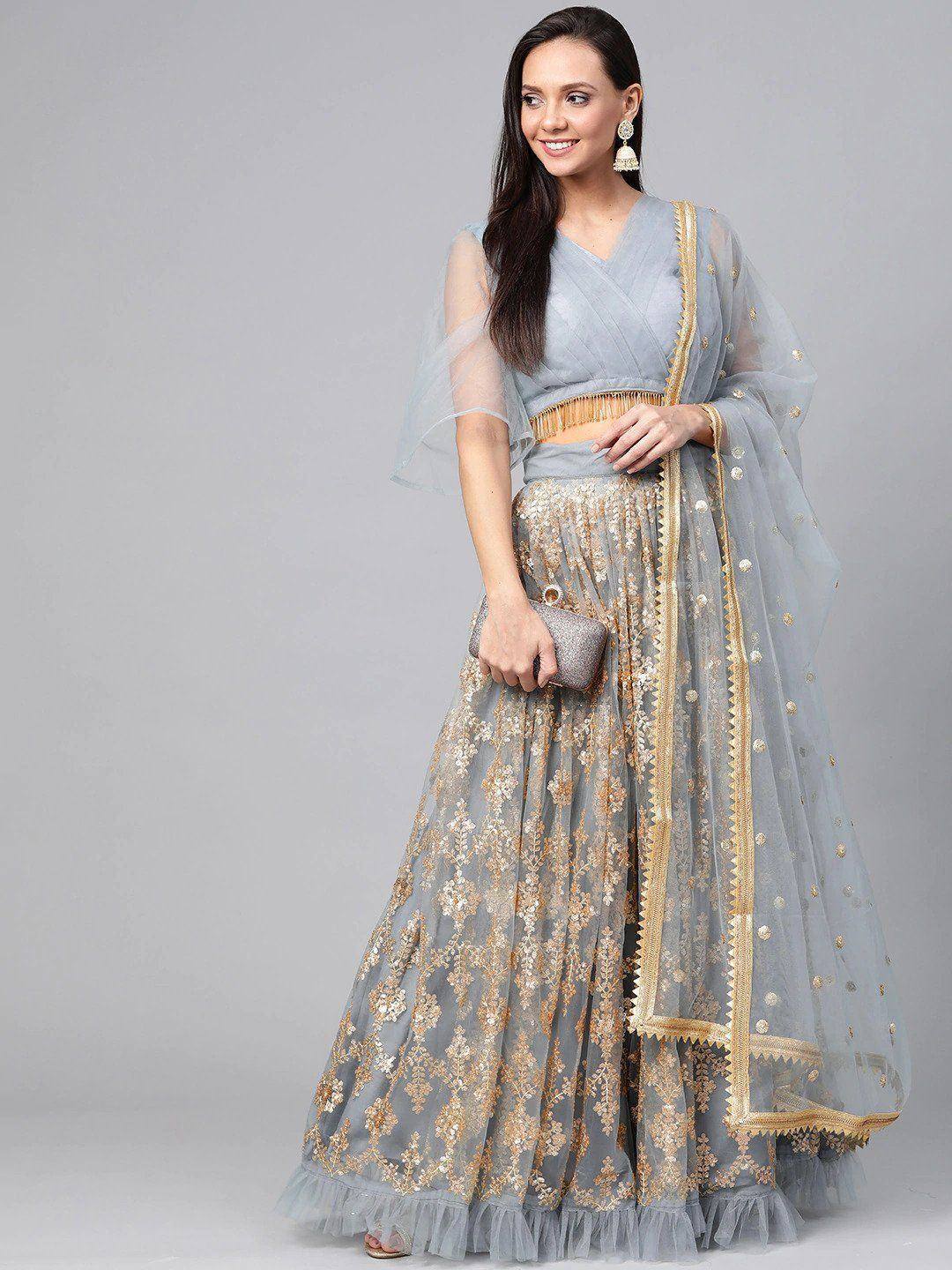 Light blue lehenga choli with gold embroidery, sheer dupatta, and tassel belt for Indian ethnic wear
