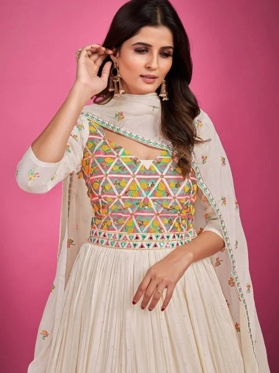 Woman in ivory embroidered ethnic gown with colorful geometric bodice and dupatta