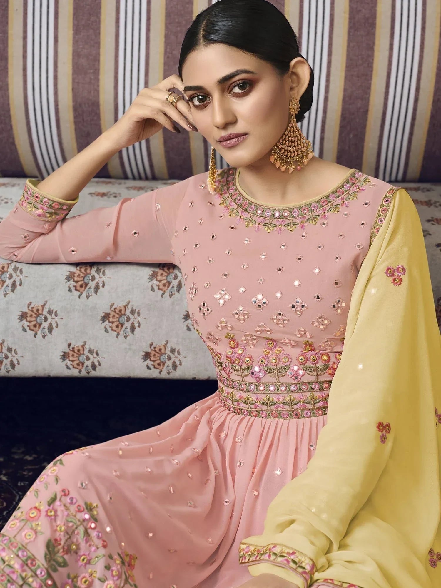 Woman in pastel pink embroidered Anarkali suit with yellow dupatta, Indian ethnic wear