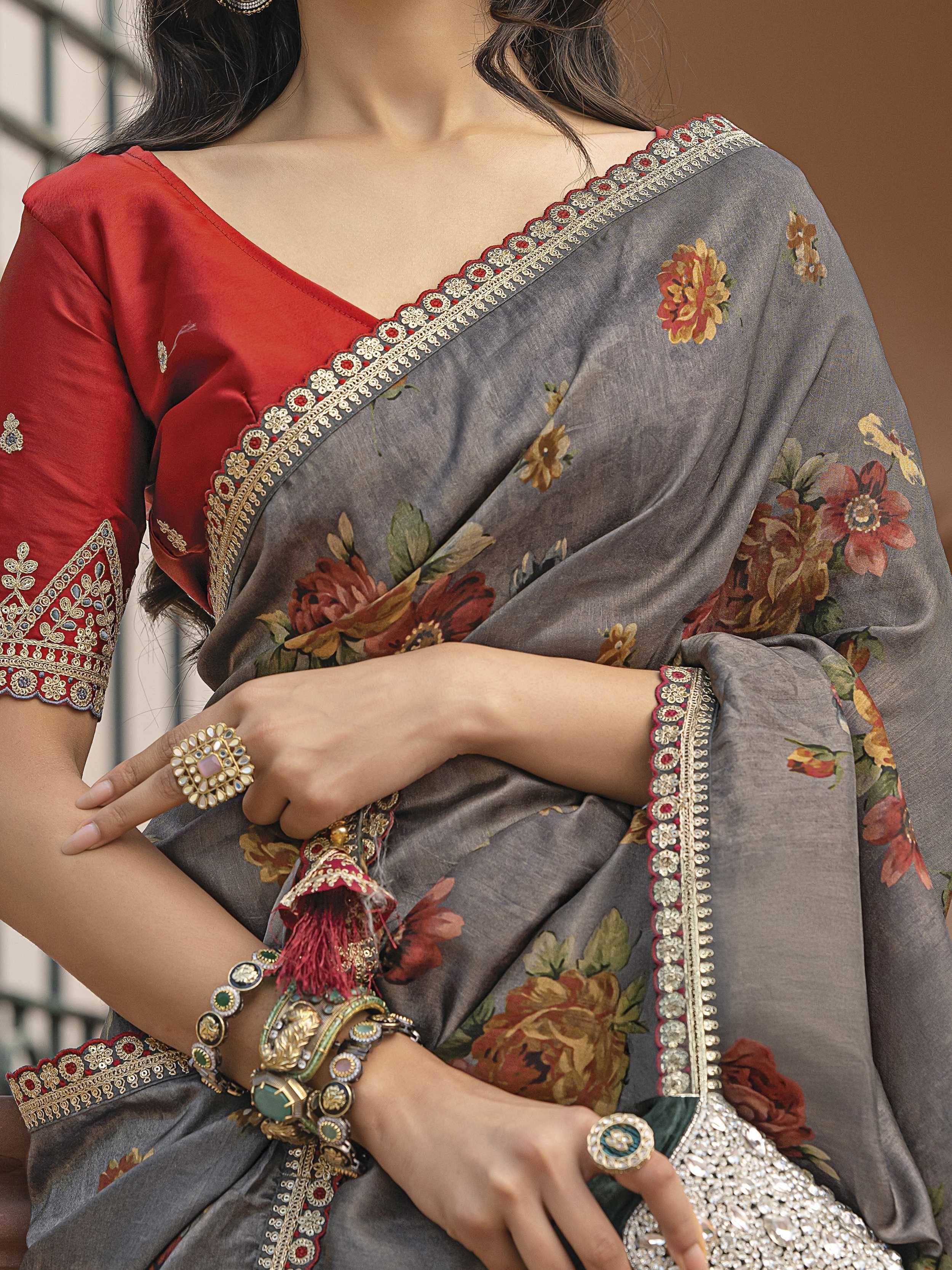 Grey floral saree with red blouse, gold embroidery, and traditional Indian jewelry for ethnic wear