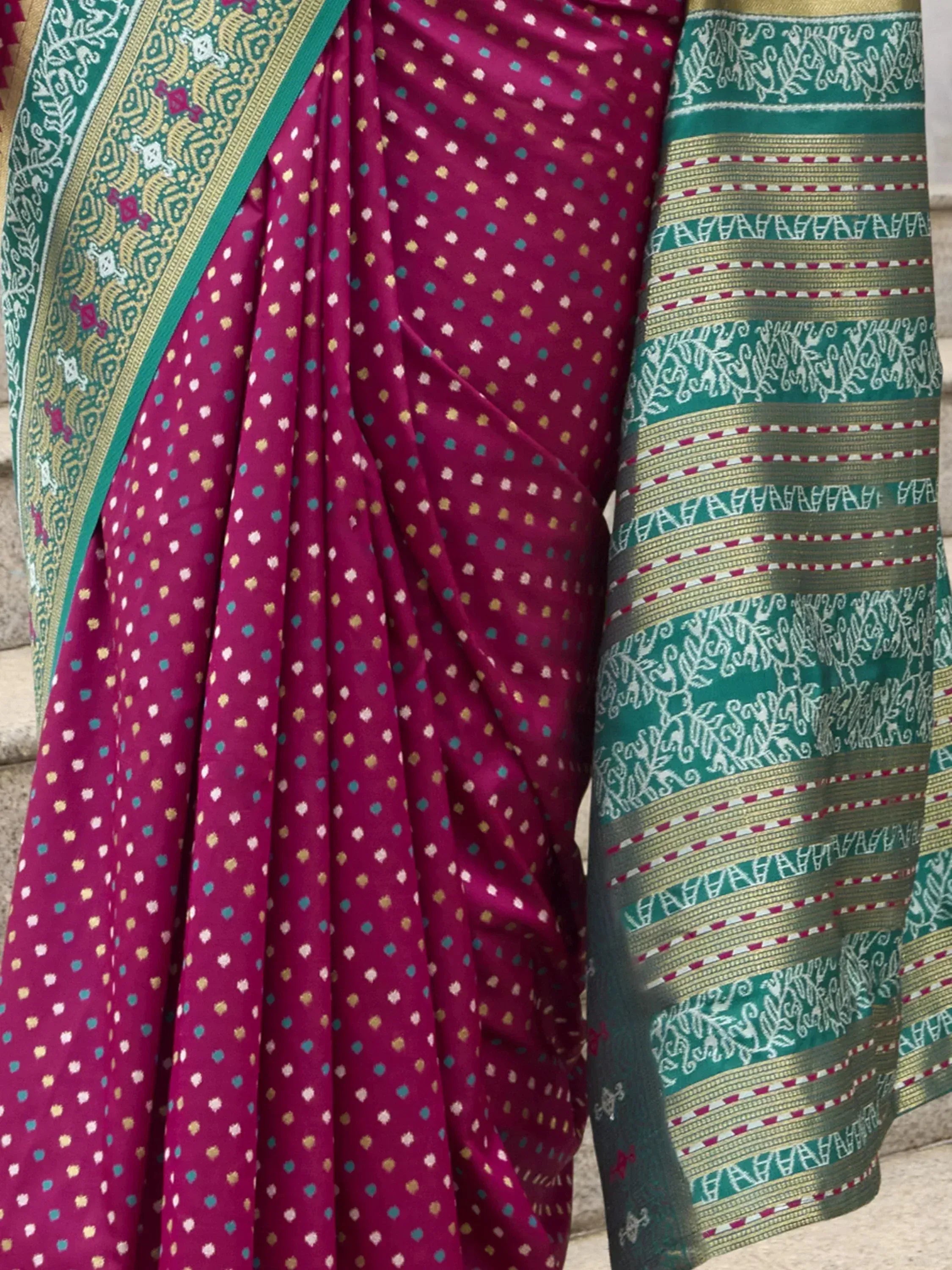 Elegant magenta saree with polka dots and intricate green border, perfect for Indian ethnic wear