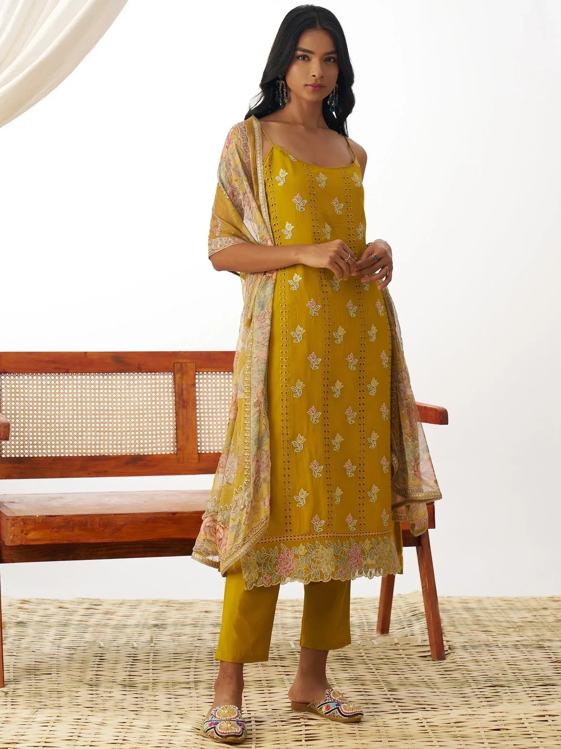 Mustard yellow embroidered kurta with floral dupatta, styled with palazzo pants and embellished slippers for ethnic wear.