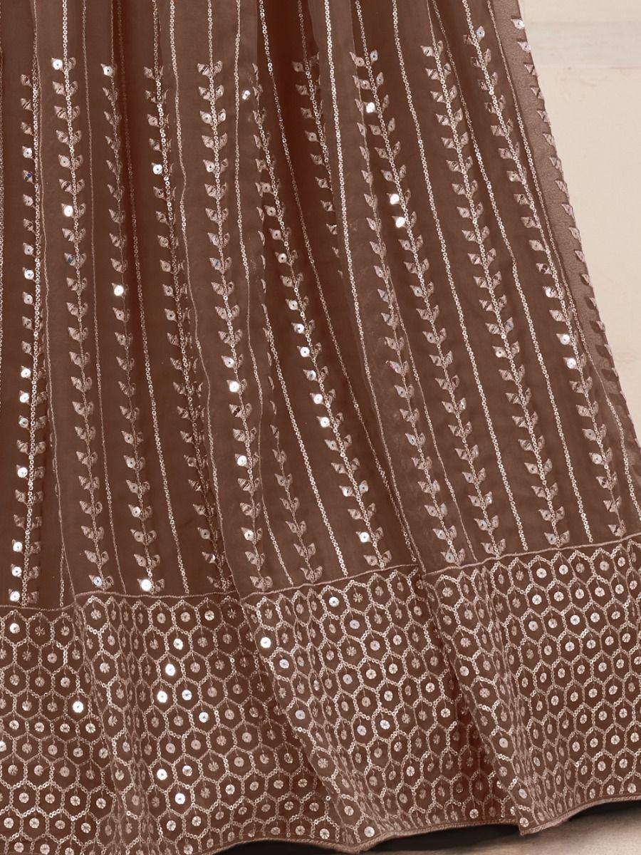 Brown ethnic lehenga with silver leaf embroidery and sequin detailing, perfect for Indian weddings or festive occasions.