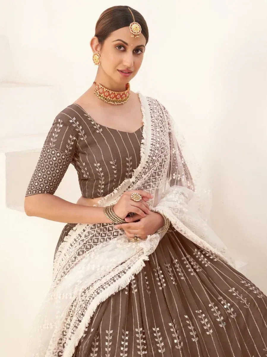 Brown embroidered lehenga choli with white dupatta, perfect for Indian ethnic wear occasions.
