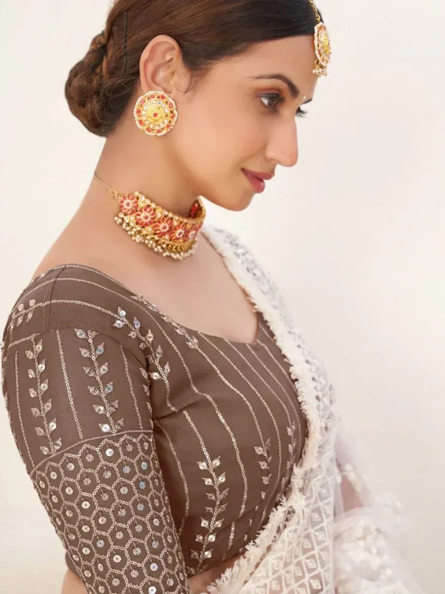 Brown embroidered blouse with white saree, traditional Indian jewelry, ethnic wear