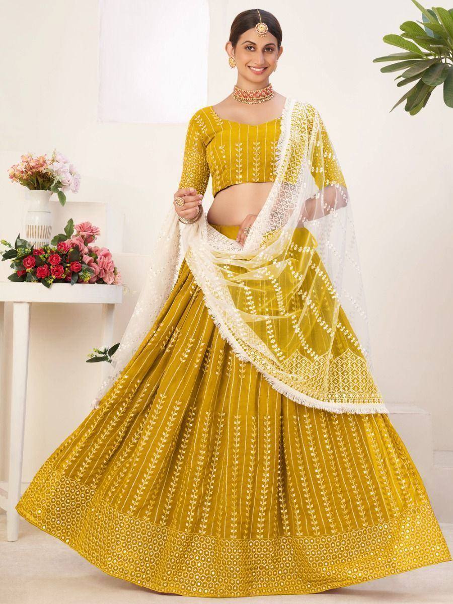 Yellow embroidered lehenga choli with white dupatta, perfect for Indian weddings and festive occasions