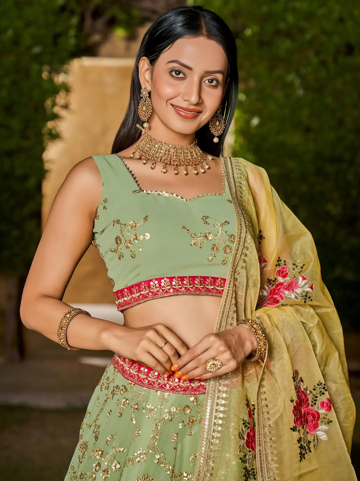 Green embroidered lehenga choli with gold detailing and floral dupatta, perfect for Indian ethnic wear