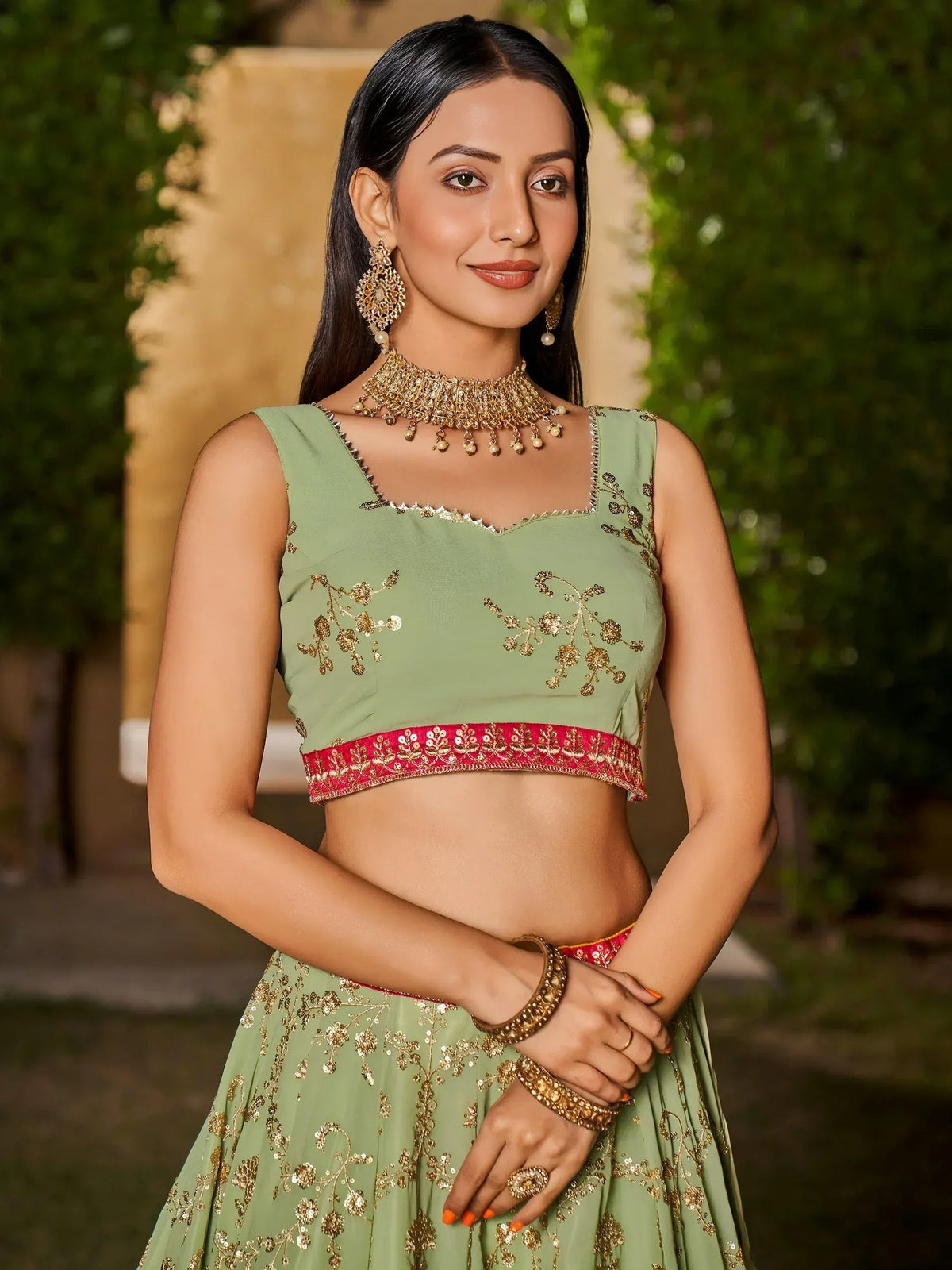 Green embroidered lehenga choli with gold detailing, perfect for Indian ethnic wear and festive occasions.