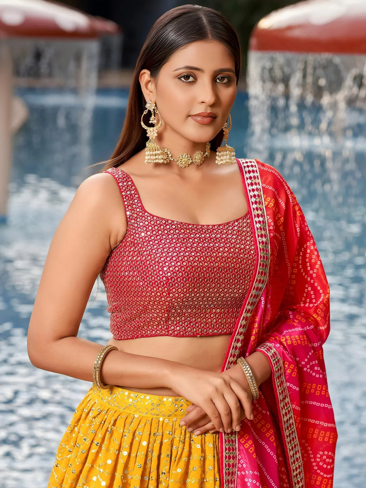 Red and yellow sequin lehenga choli with matching dupatta, perfect for Indian ethnic wear occasions.