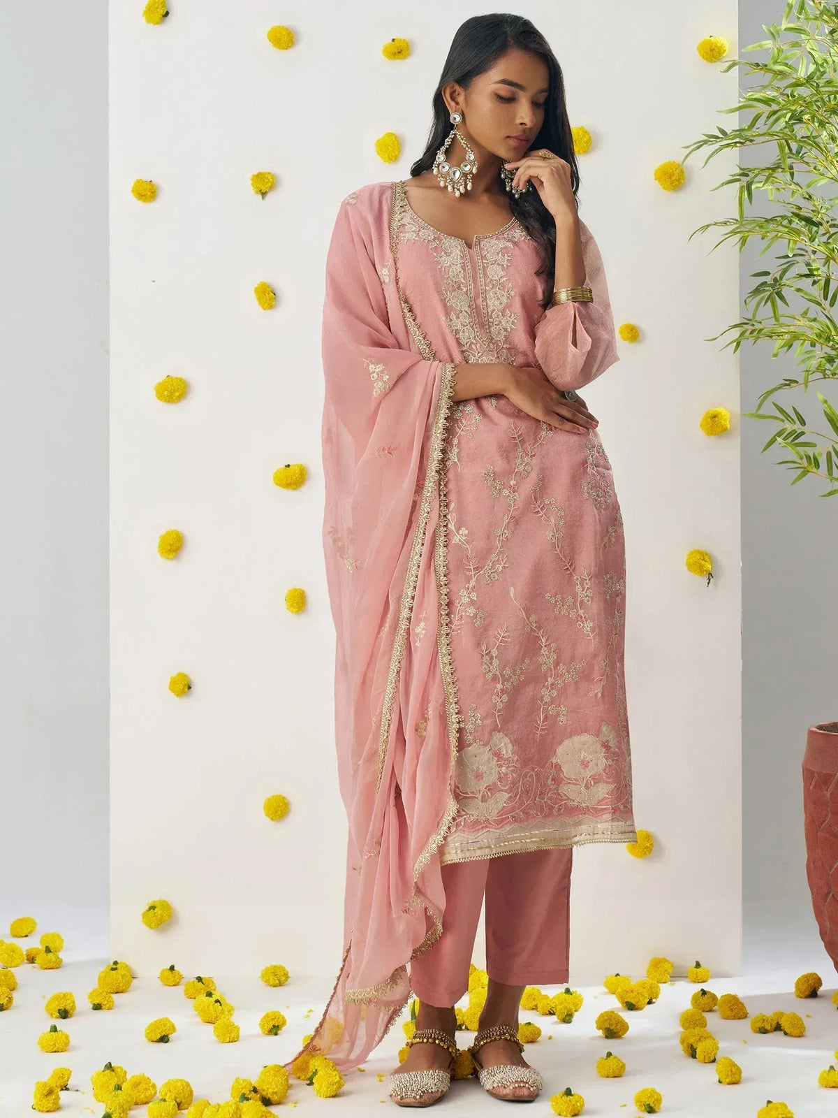 Pink embroidered salwar kameez with floral details, gold trim, and matching dupatta for ethnic wear