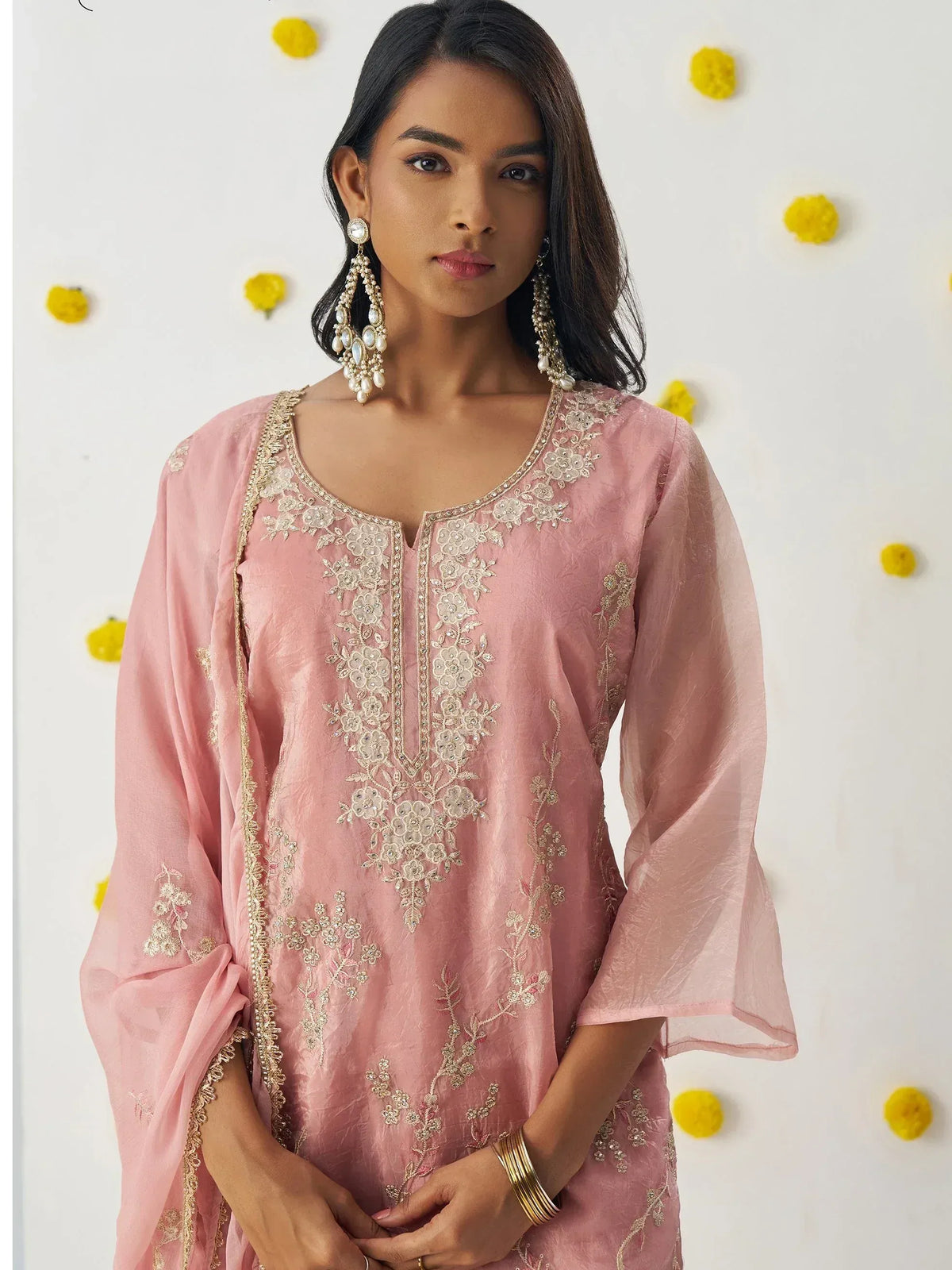 Pink embroidered ethnic kurti with floral detailing, gold trim, and bell sleeves for women