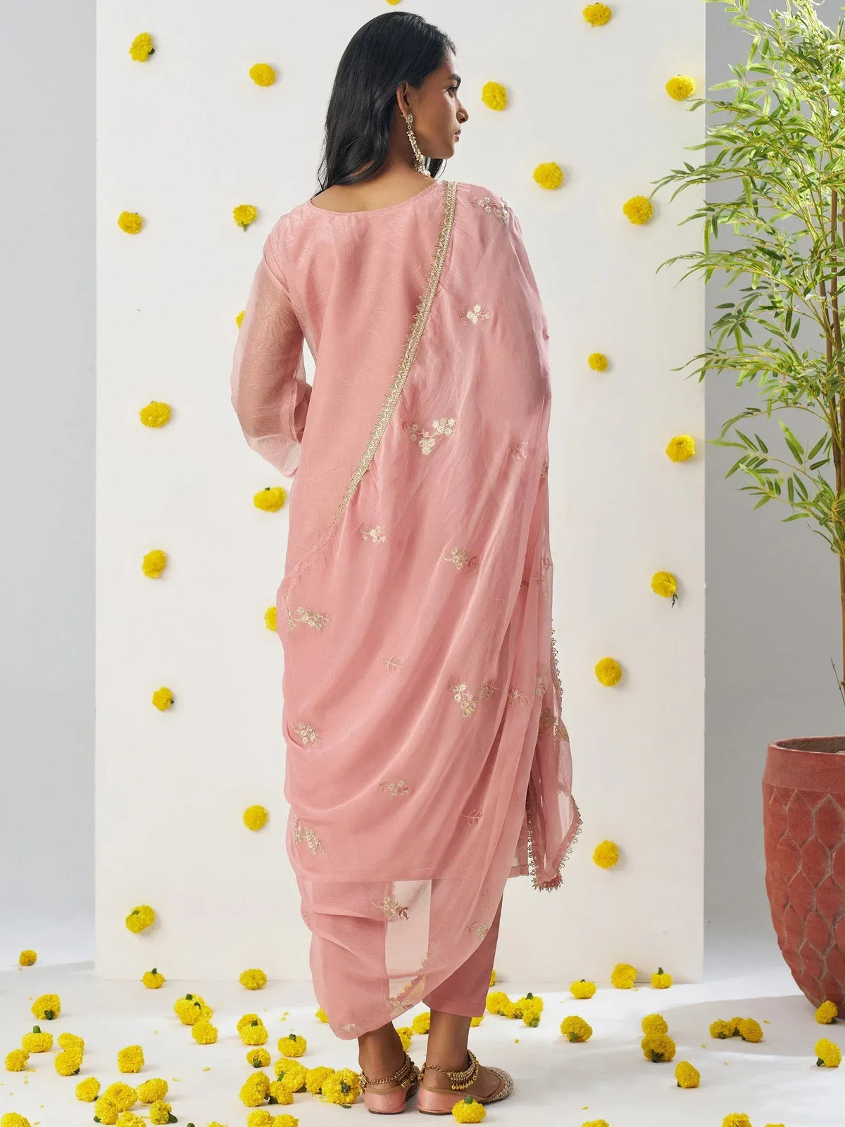 Pink embroidered salwar kameez with sheer dupatta, floral backdrop, ethnic wear