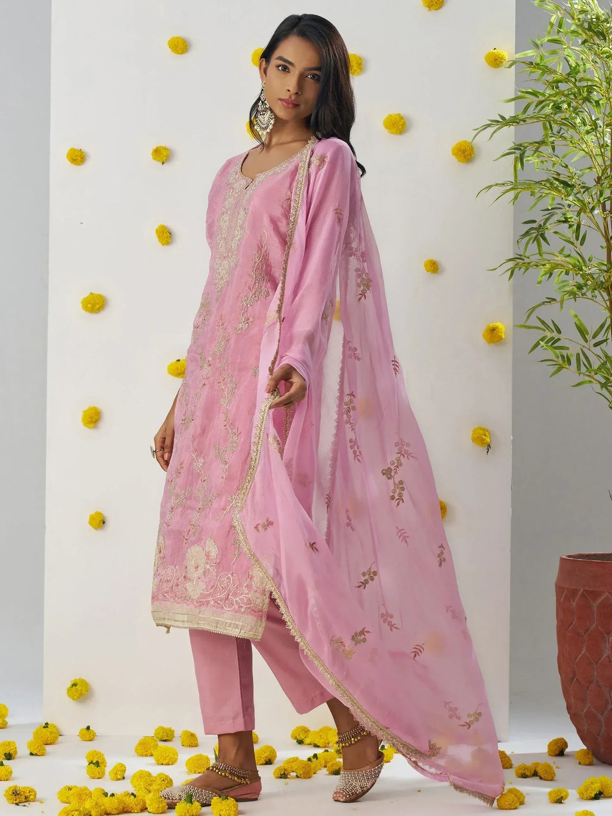 Pink embroidered salwar kameez with matching dupatta, floral embellishments, and gold trim for ethnic wear