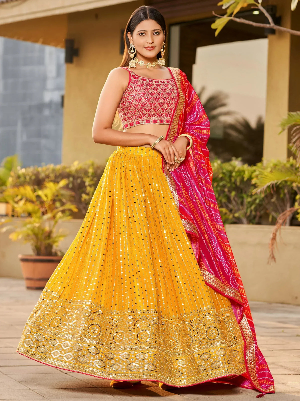 Yellow and pink embroidered lehenga choli with mirror work and dupatta