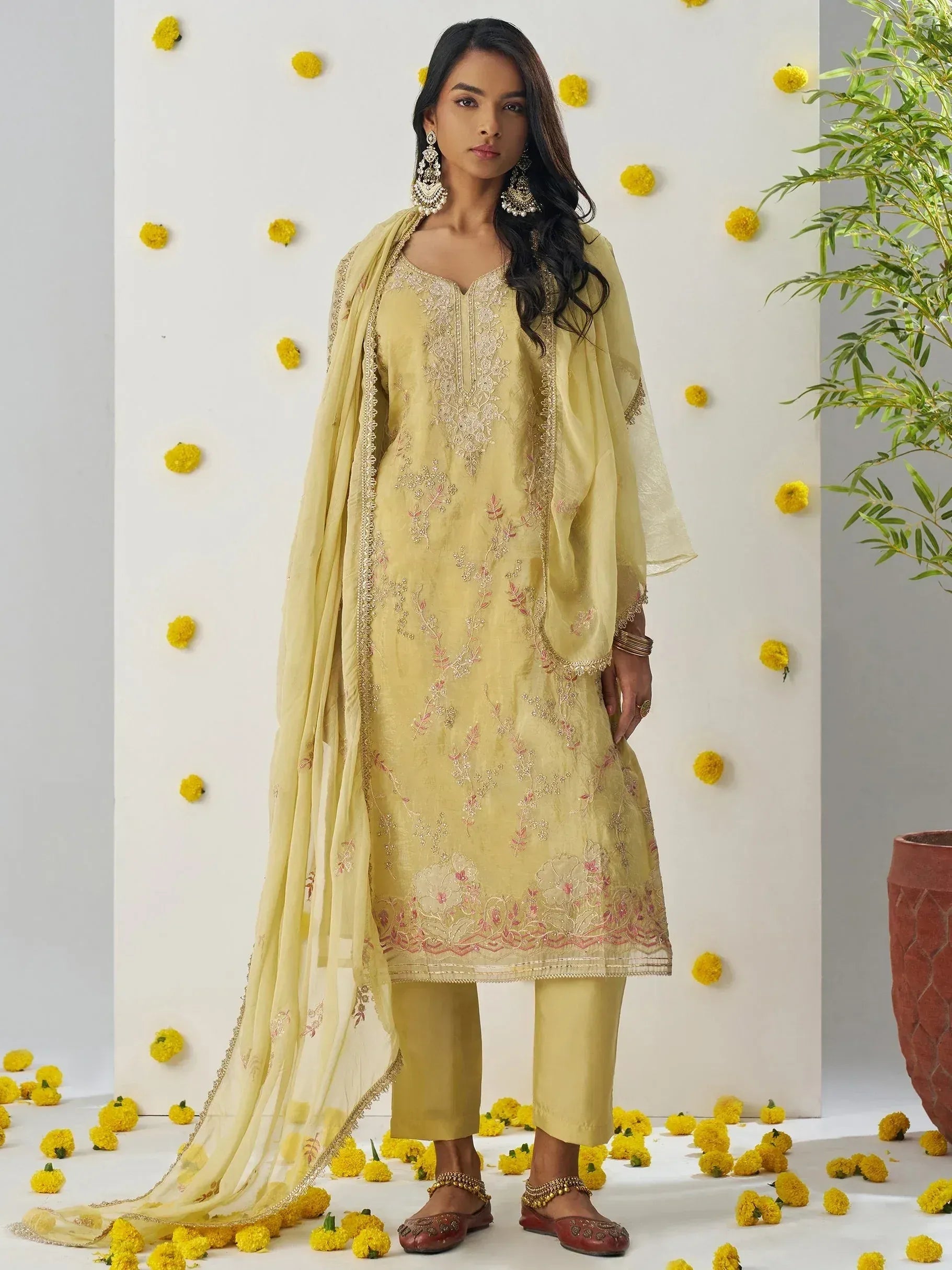 Yellow embroidered salwar kameez with dupatta, floral embellishments, and matching pants for ethnic wear