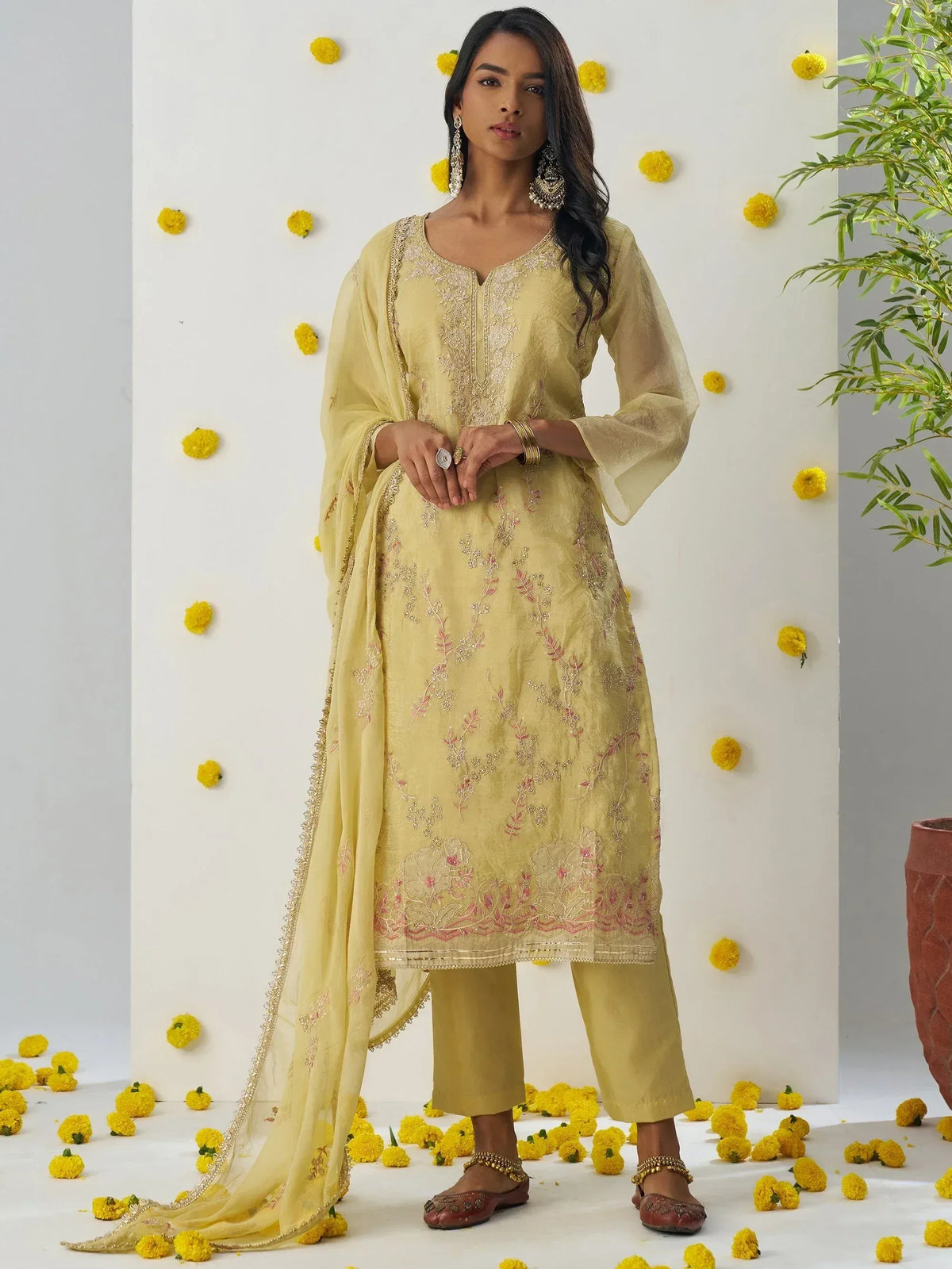 Yellow embroidered salwar kameez with floral details, perfect for ethnic occasions
