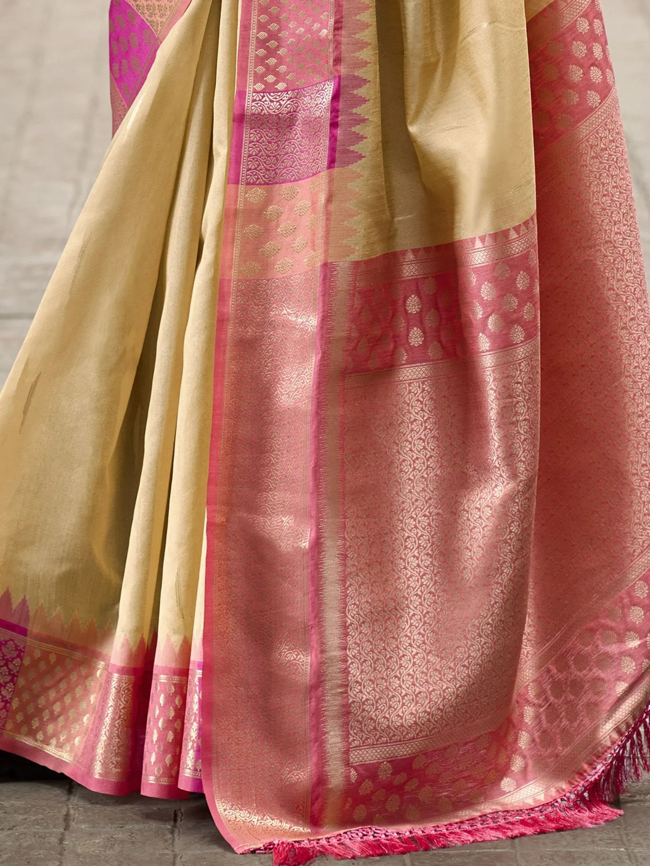 Elegant beige and pink Banarasi saree with intricate gold zari work and traditional border patterns