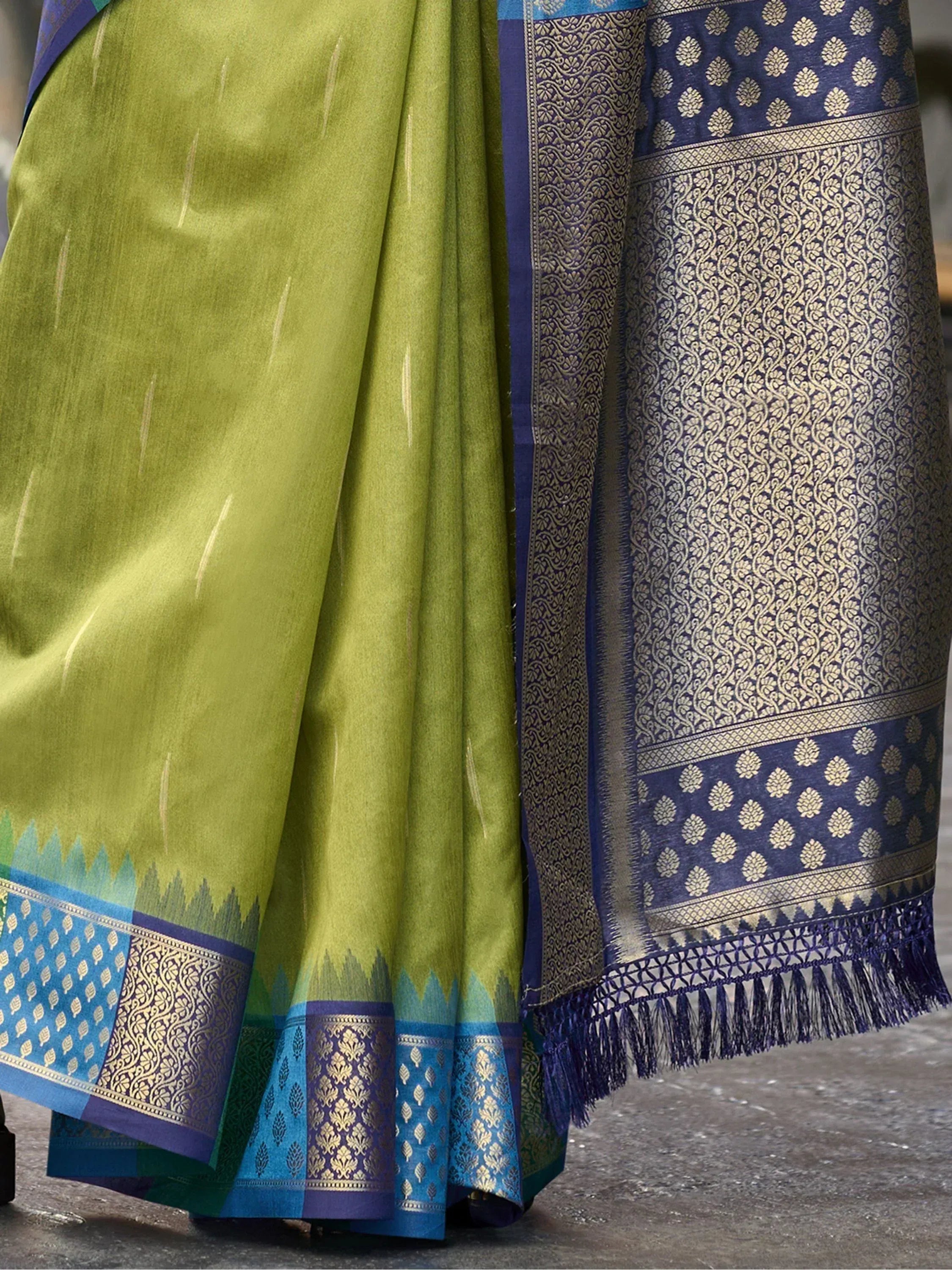 Green and blue designer saree with intricate gold zari border and tassels, ethnic wear