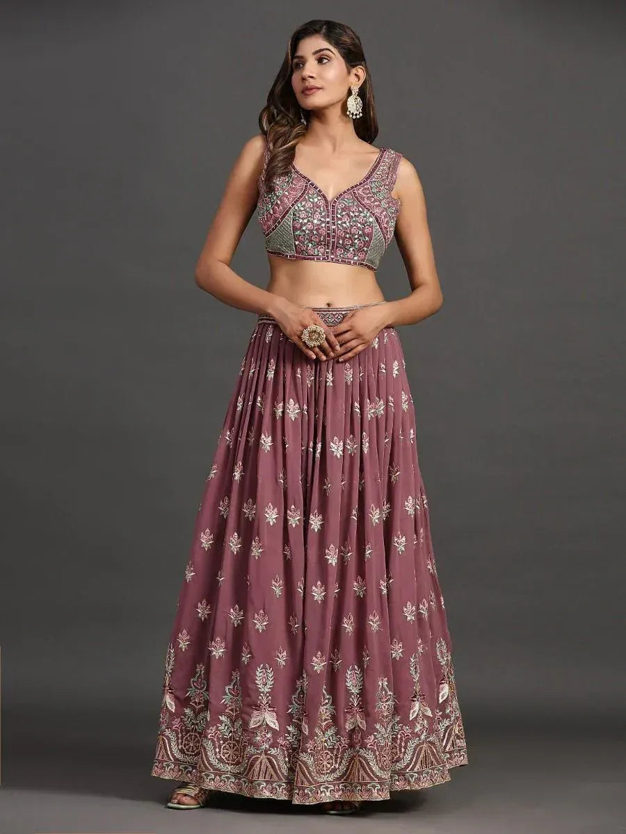 Elegant mauve lehenga choli with intricate floral embroidery and embellished crop top, perfect for Indian ethnic occasions.