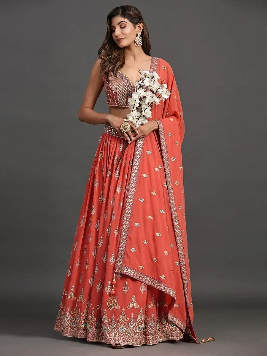 Coral designer lehenga choli with intricate embroidery, perfect for weddings and festive occasions