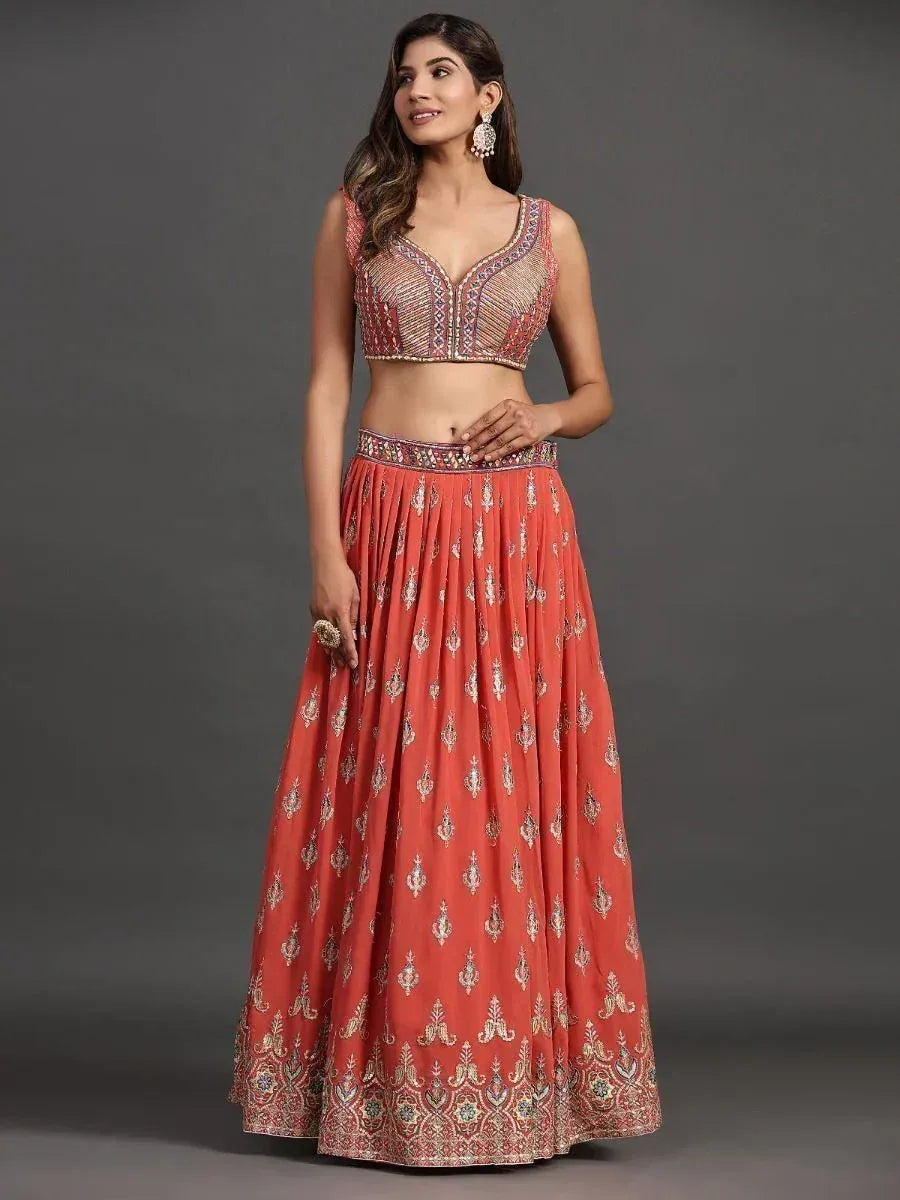 Coral embroidered lehenga choli with detailed blouse and flared skirt, perfect for Indian ethnic occasions