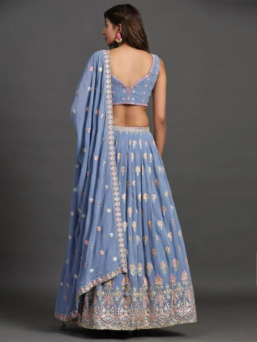 Blue embroidered lehenga choli with floral motifs and backless blouse, perfect for Indian ethnic occasions.