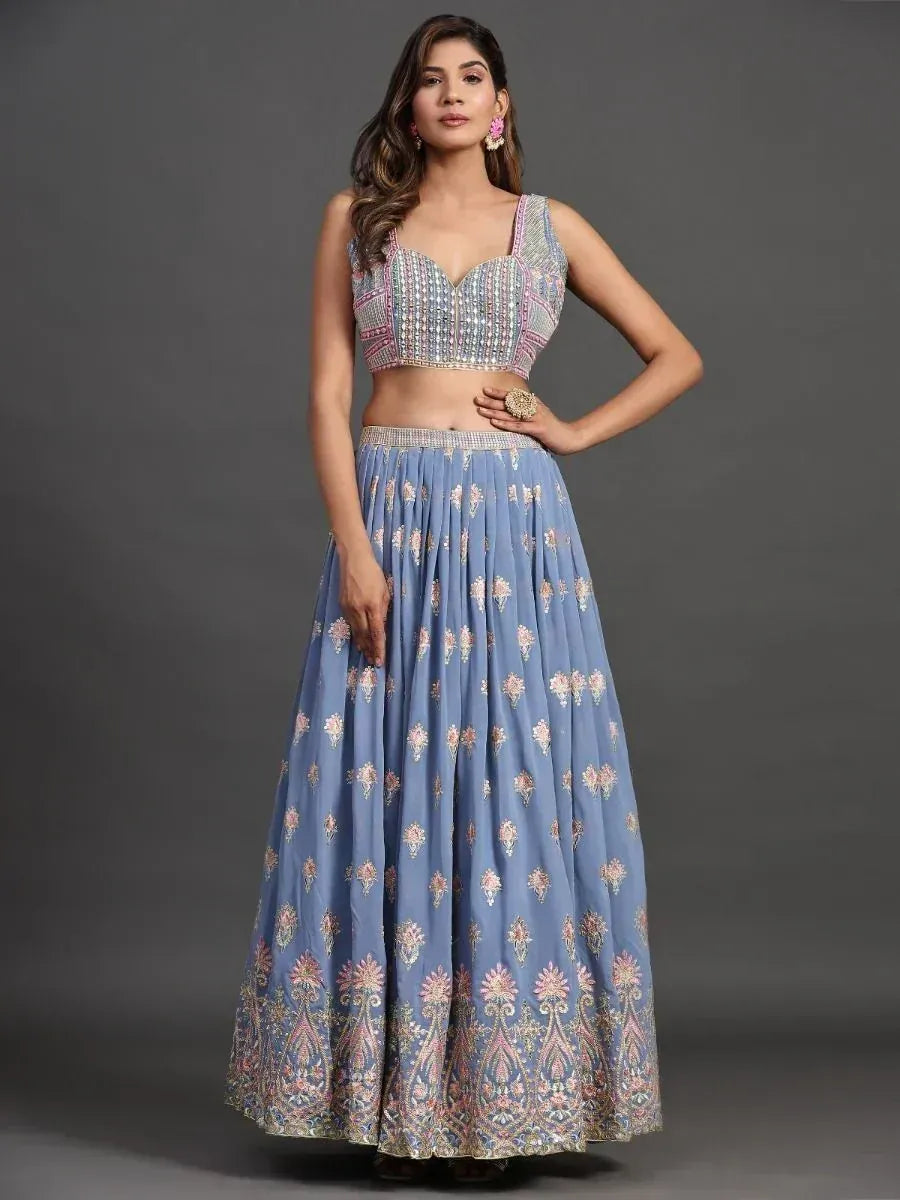 Blue embroidered lehenga choli with floral motifs and embellished crop top, perfect for Indian ethnic wear occasions.