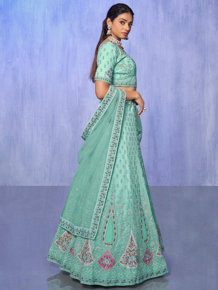 Mint green designer lehenga choli with intricate embroidery and embellished border, perfect for Indian ethnic occasions